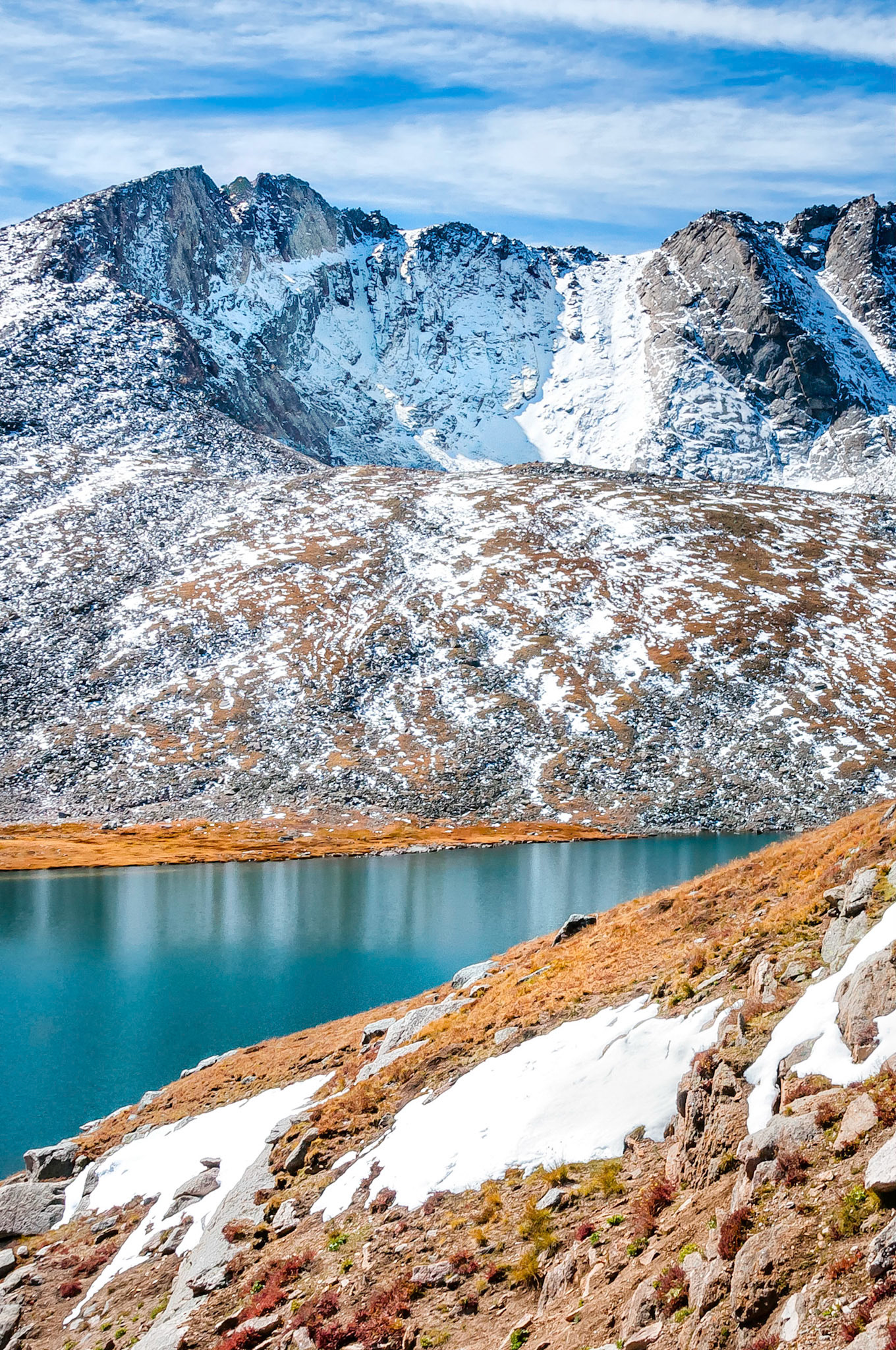 A slight breeze begins to disturb the reflections in the still waters of Summit Lake. Mount Evans, a 14,264 foot, (4,348 meter), high peak located west of Denver in Colorado, USA.