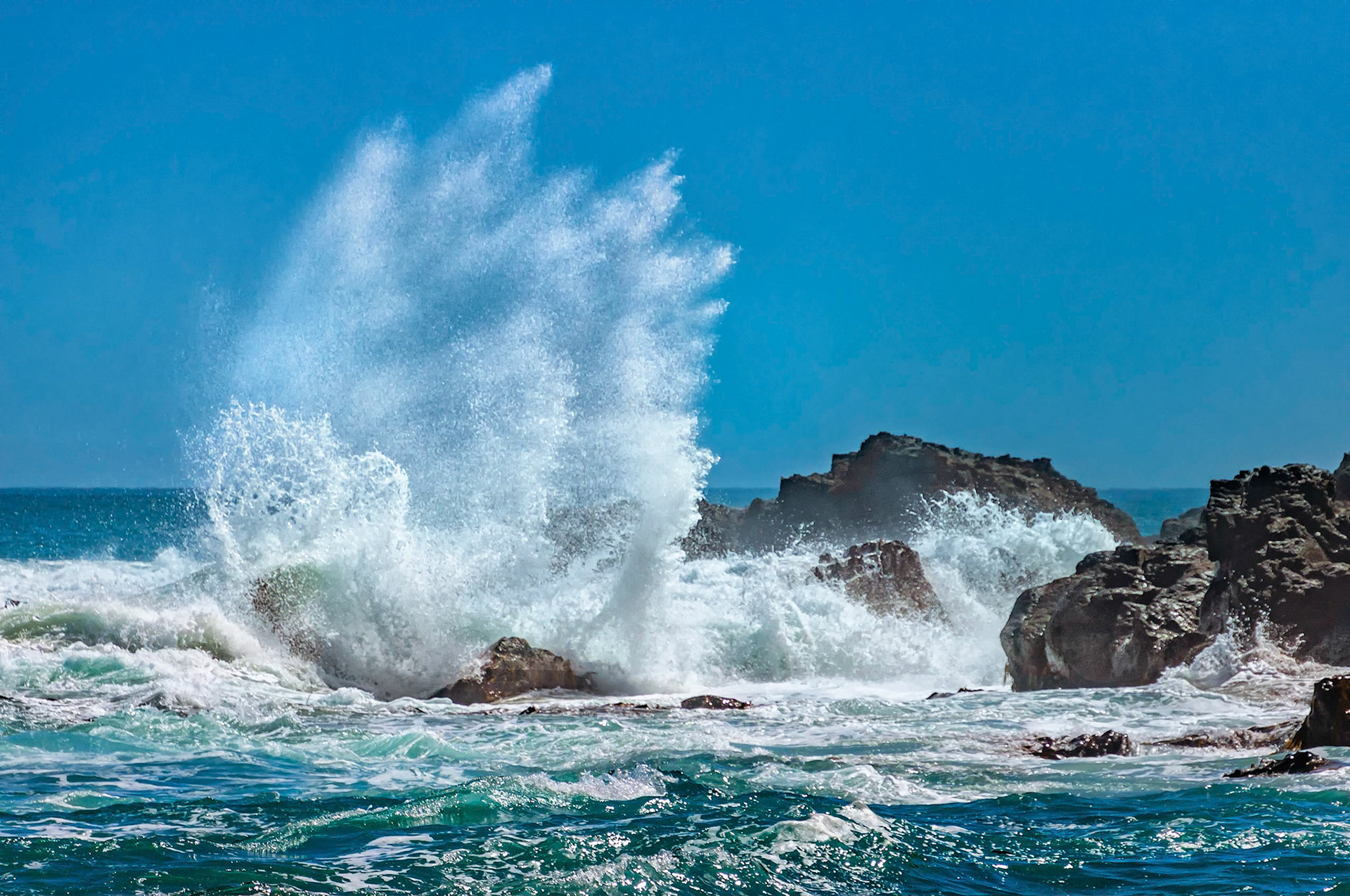 Expending its pent-up energy on a rocky headland with a final spectacular display of mist and spray, a Bass Strait ocean swell reaches the coastline of the Great Otway National Park in Victoria, Australia.