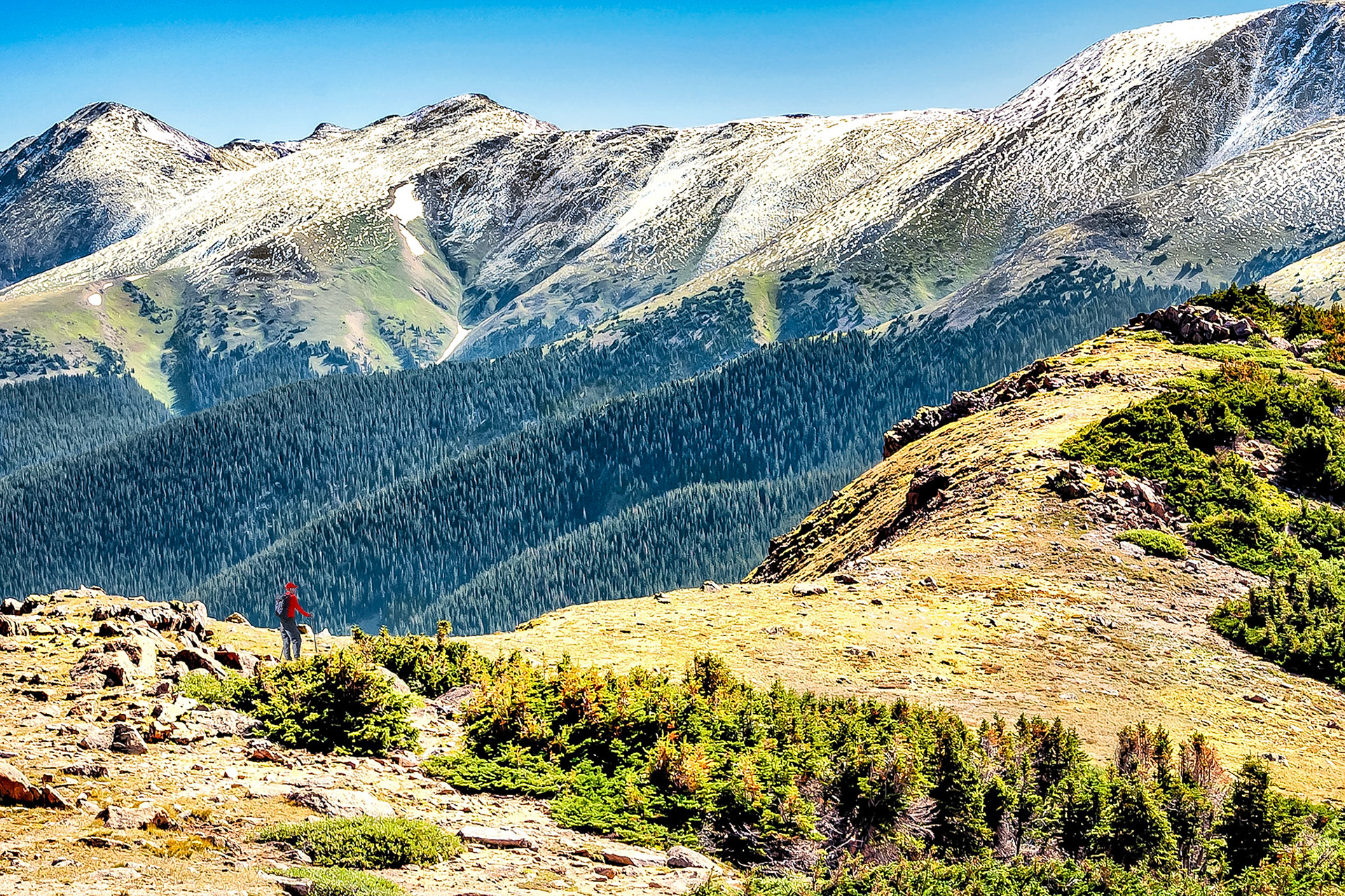 Taking in the views while hiking along the Contiental Divide near Berthoud Pass, Colorado, USA. Here, an early autumn storm has dusted the higher ridge lines with a light covering of snow.