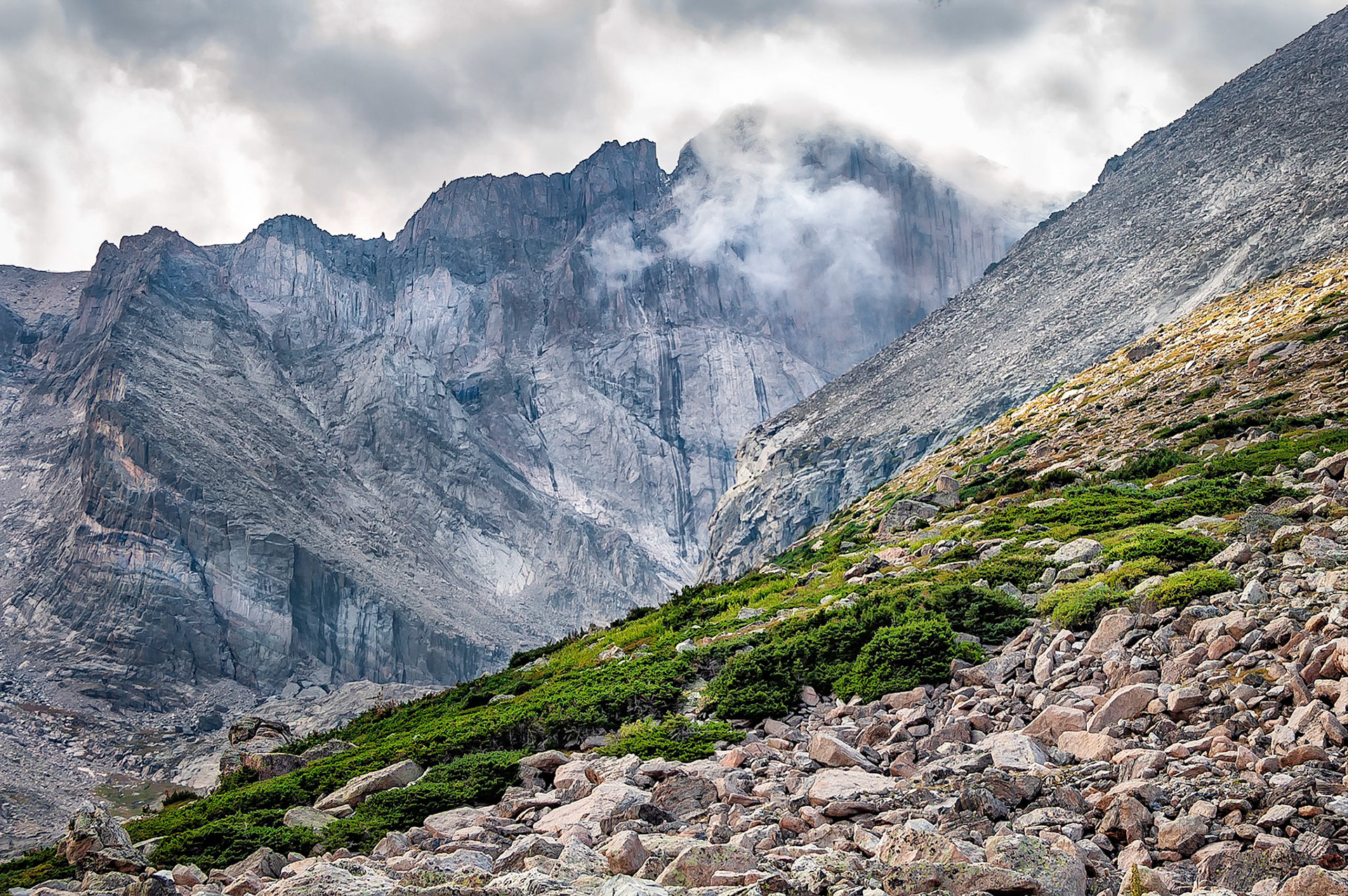 Weather changes quickly in the high country... clouds move onto the north face of Longs Peak, (14,259 feet=4346 m), in the Rocky Mountain National Park, Colorado, USA. The scree slopes of Mt Lady Washington are on the right.