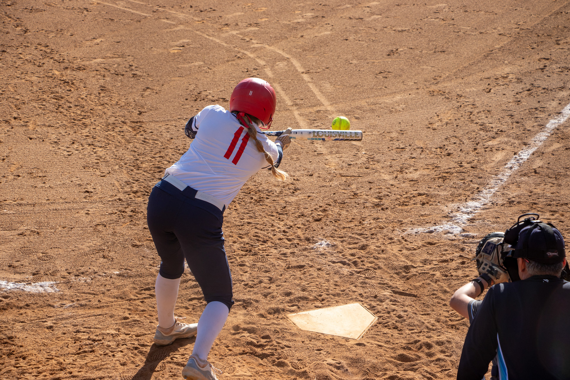 SALEM, Va., March 1, 2025 — Bunt: Radford infielder Grace Bechtol drops a bunt and prepares to sprint to first base. Photo: Sam Mostow