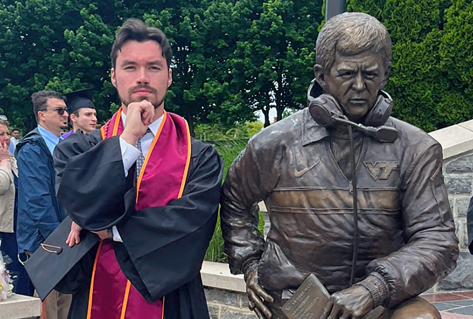BLACKSBURG, Va., May 9, 2024 — Bruckner: Alex Bruckner, a Virginia Tech alumnus, stands with a statue of longtime football coach Frank Beamer following his graduation. Photo courtesy of Alex Bruckner.