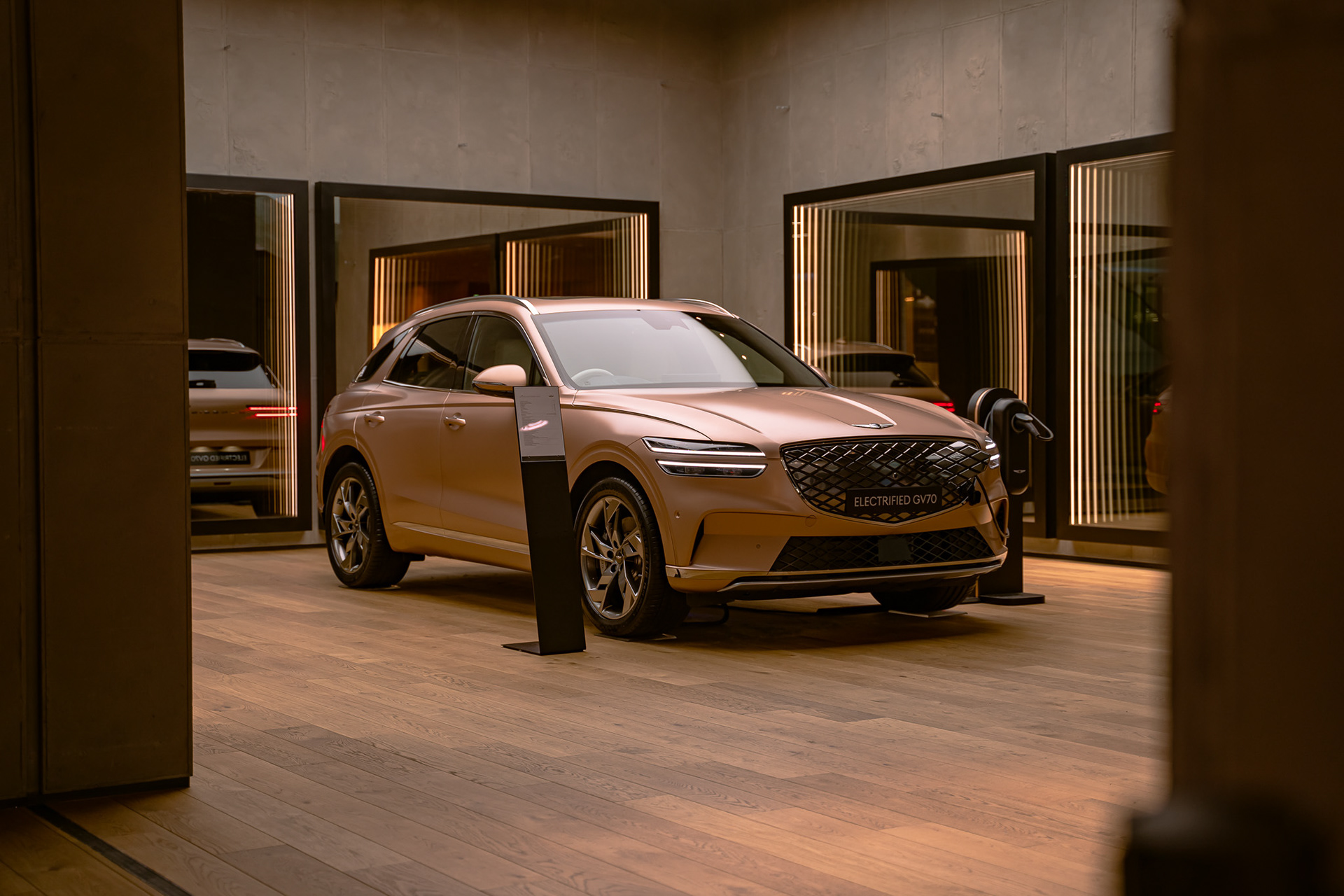 Genesis GV80 parked outside luxury building at night with warm ambient lighting