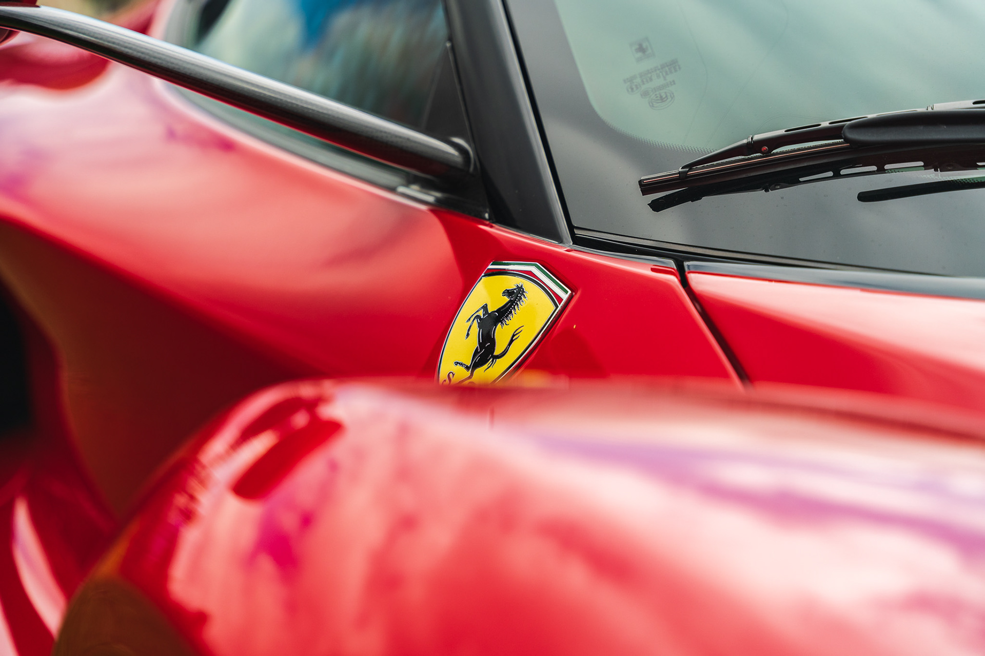Close-up of Ferrari La Ferrari bodywork and badge with glossy red finish