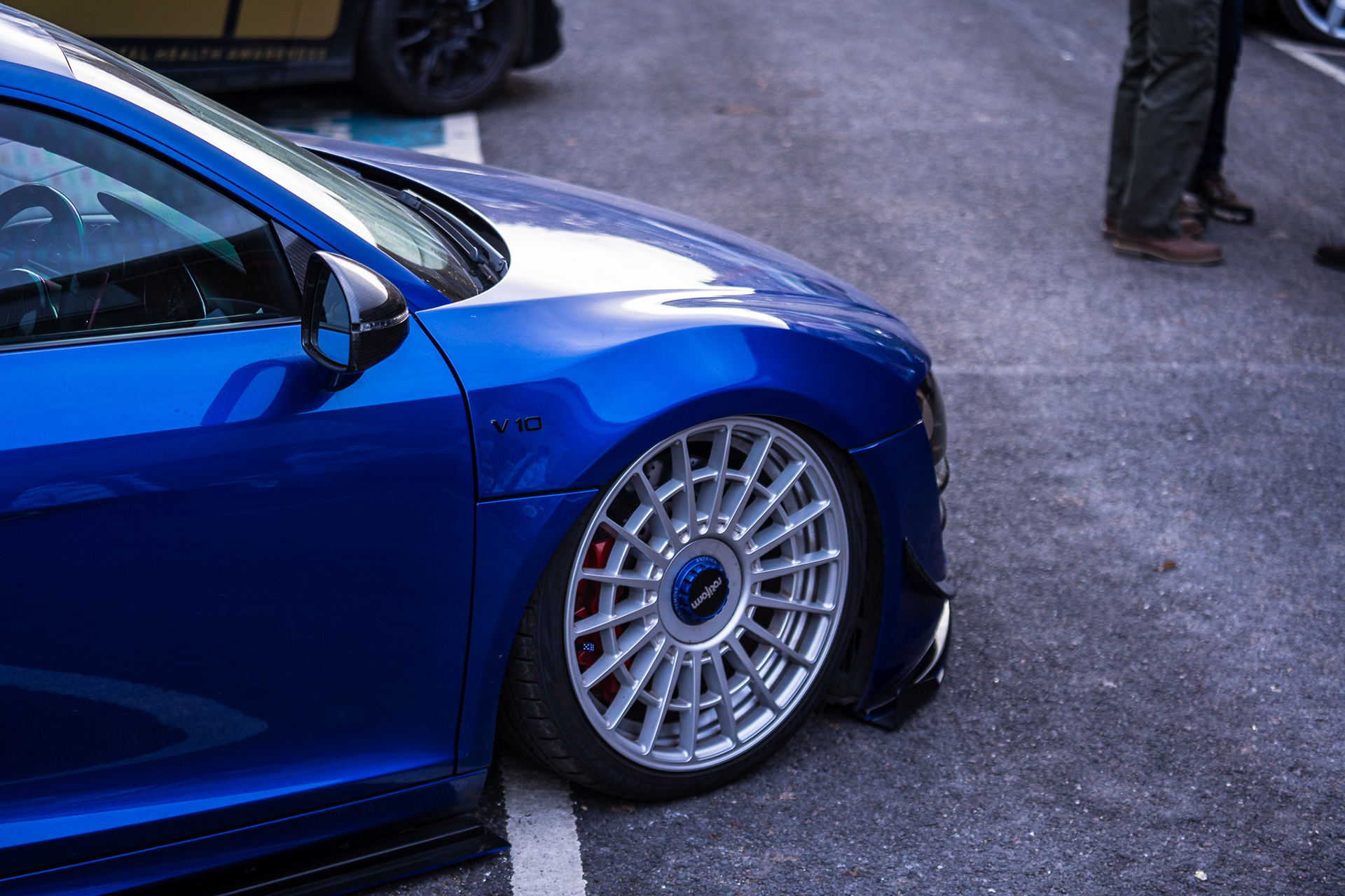 Blue modified car Audi R8 with custom wheels Rotiform in outdoor setting