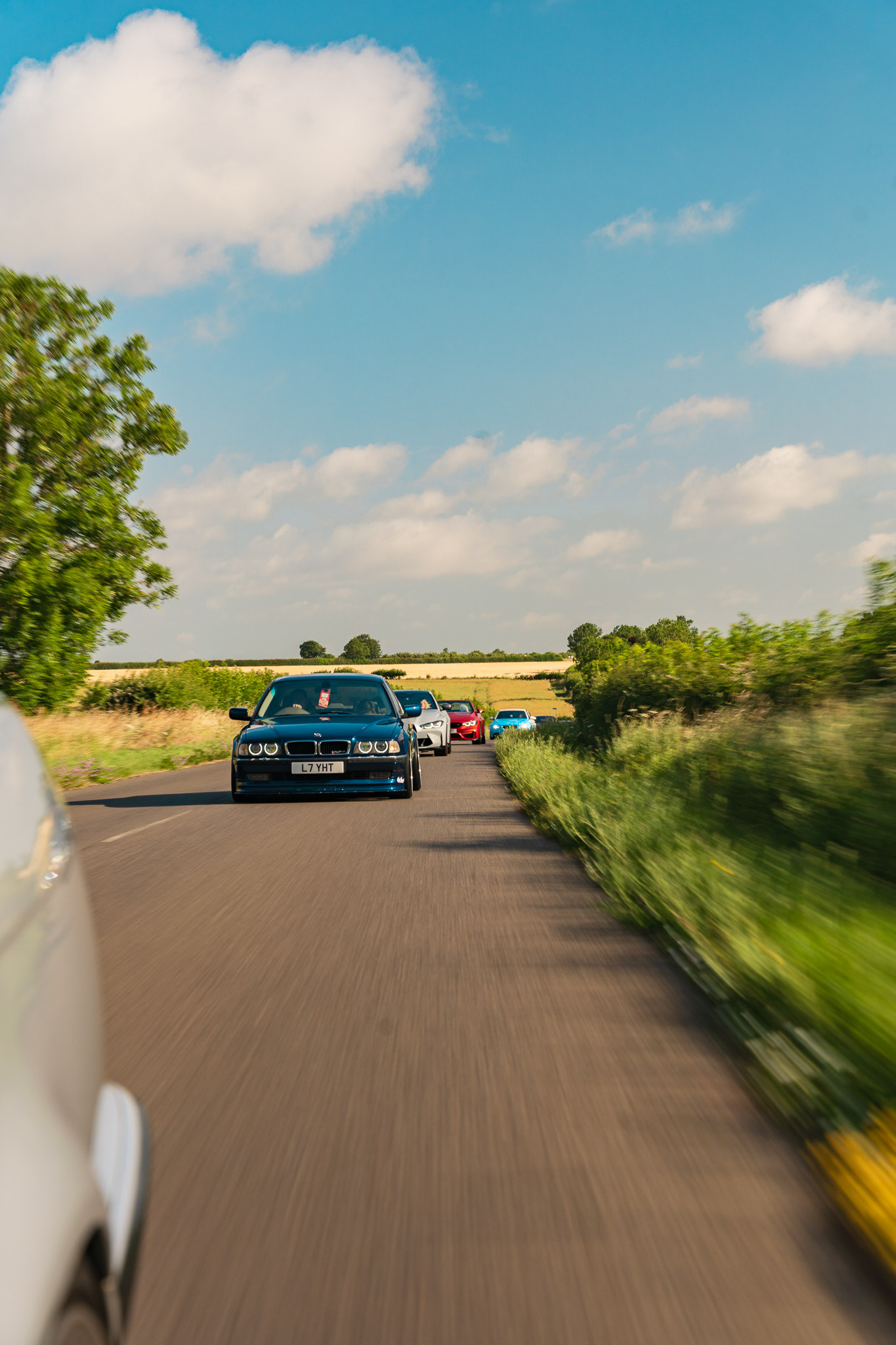 Car driving on open road with natural landscape and motion feel