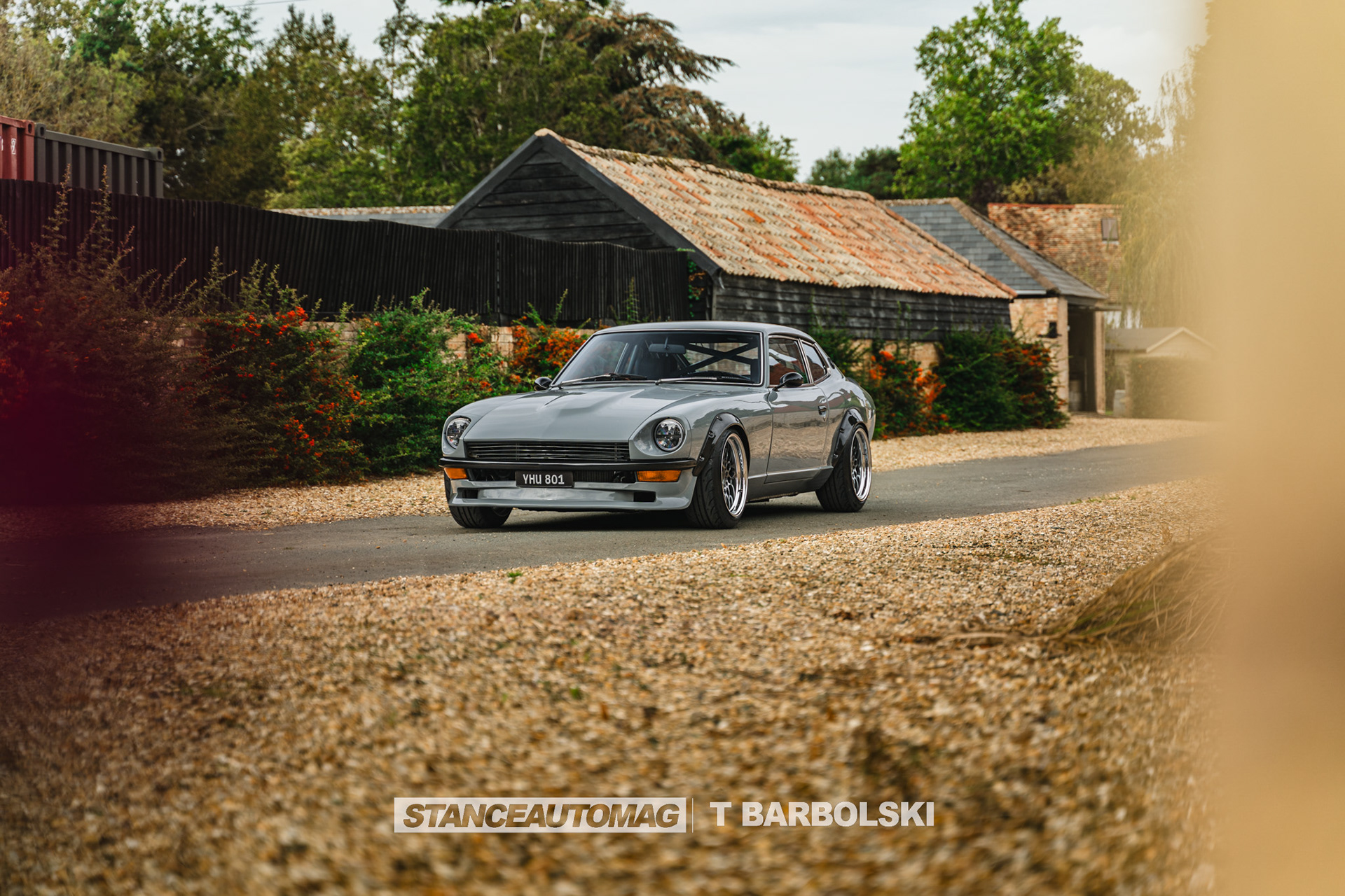 Classic Datsun 240z parked near countryside house with cinematic composition