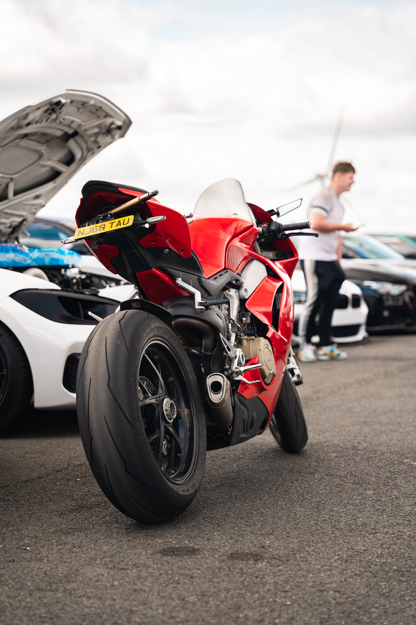 Red sports motorcycle Ducatti parked outdoors with clean composition