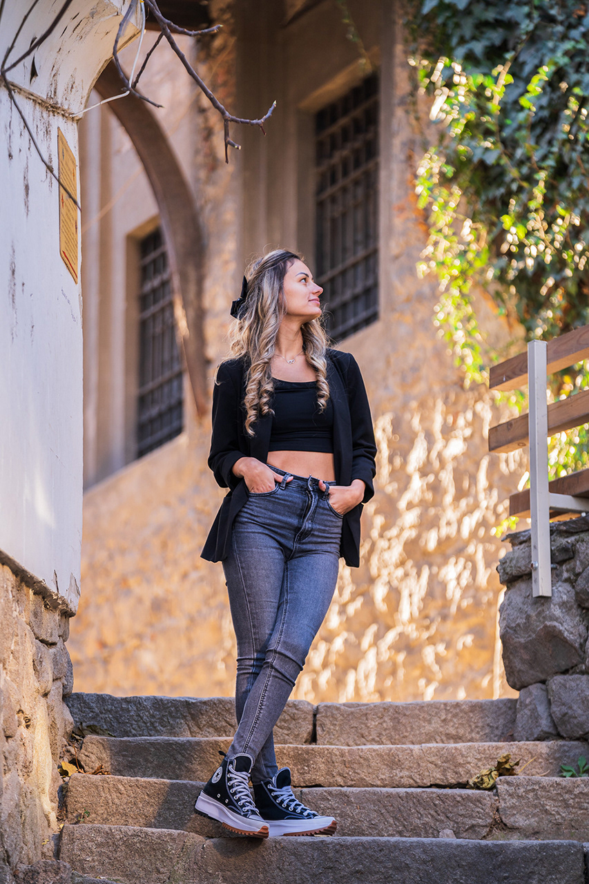Alternative view of the stone steps fashion shoot, emphasizing the textures of the historic architecture and the model's relaxed editorial pose.
