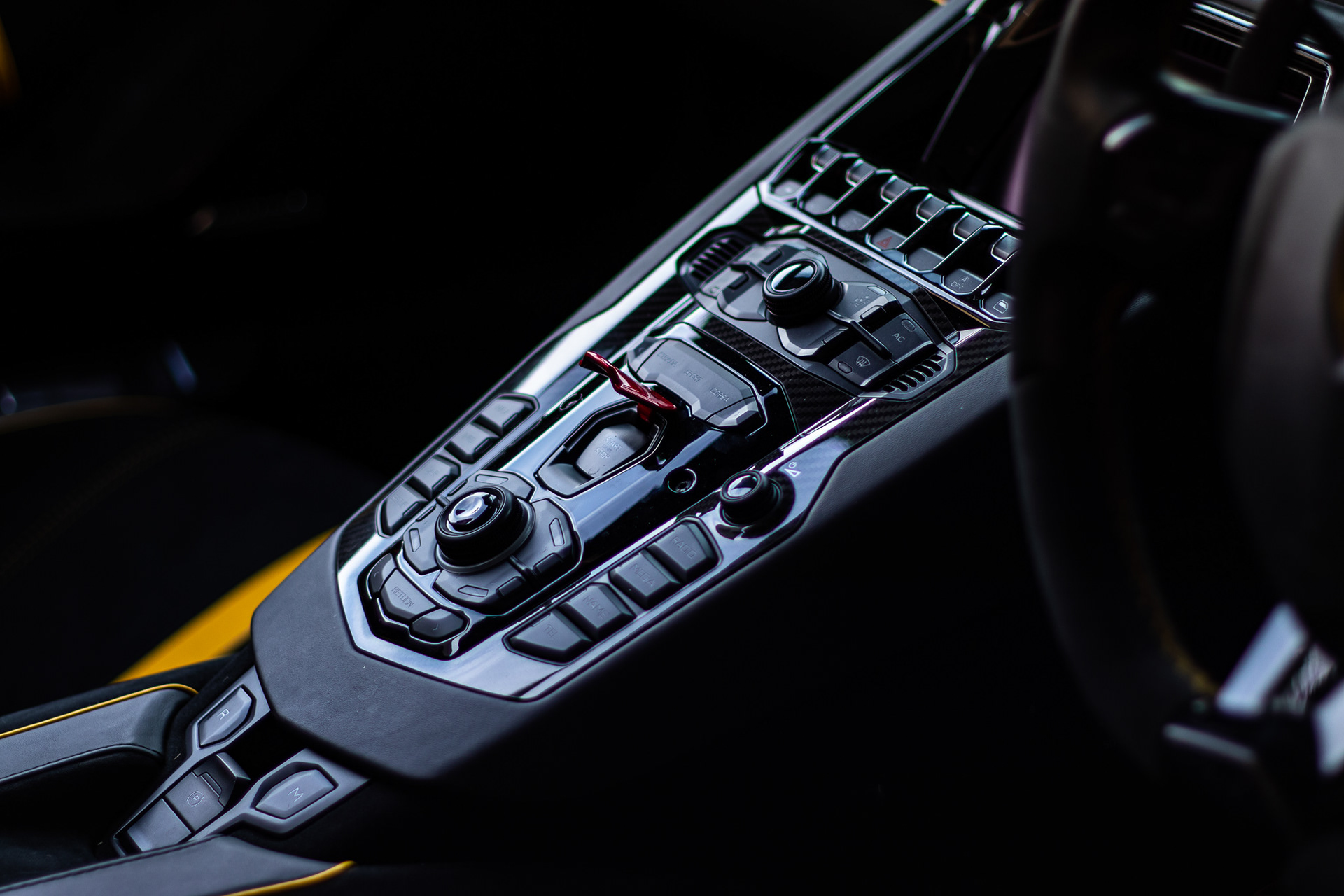 Close-up of Lamborghini Aventador interior controls with modern design and lighting