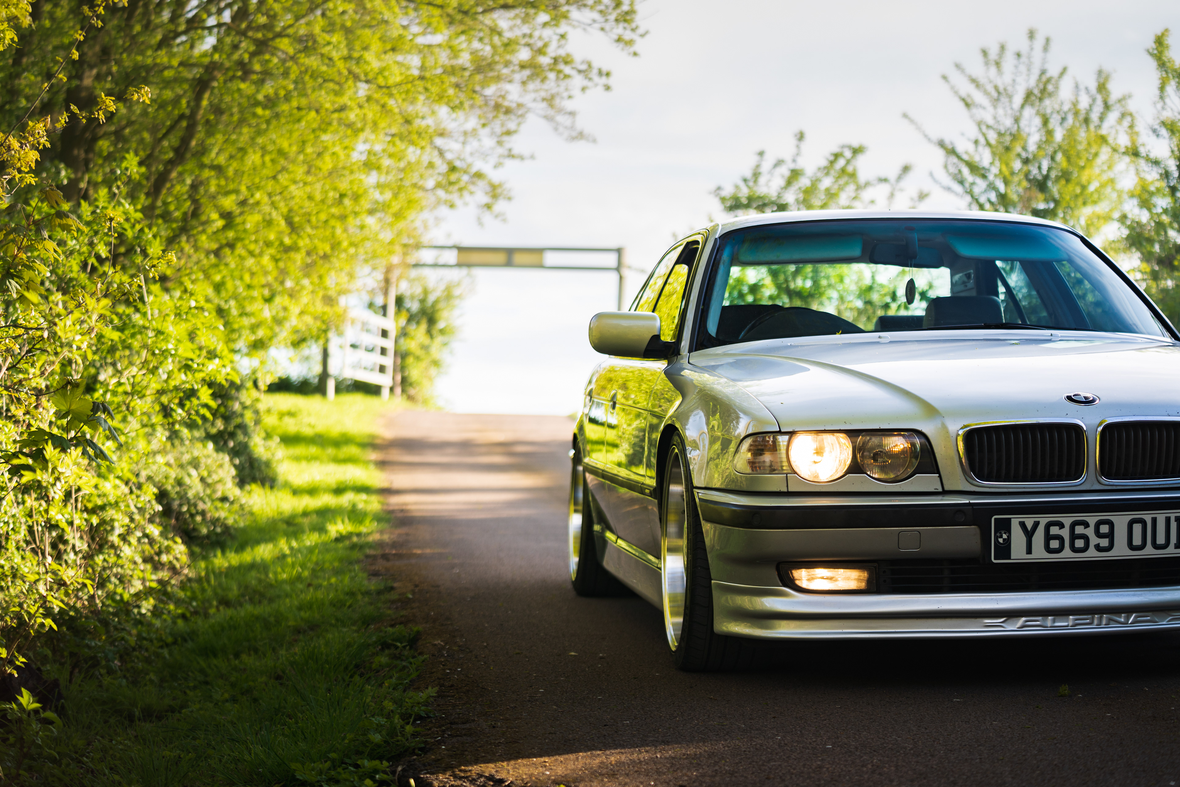 Front view automotive portrait of BMW e38 7 series under green canopy