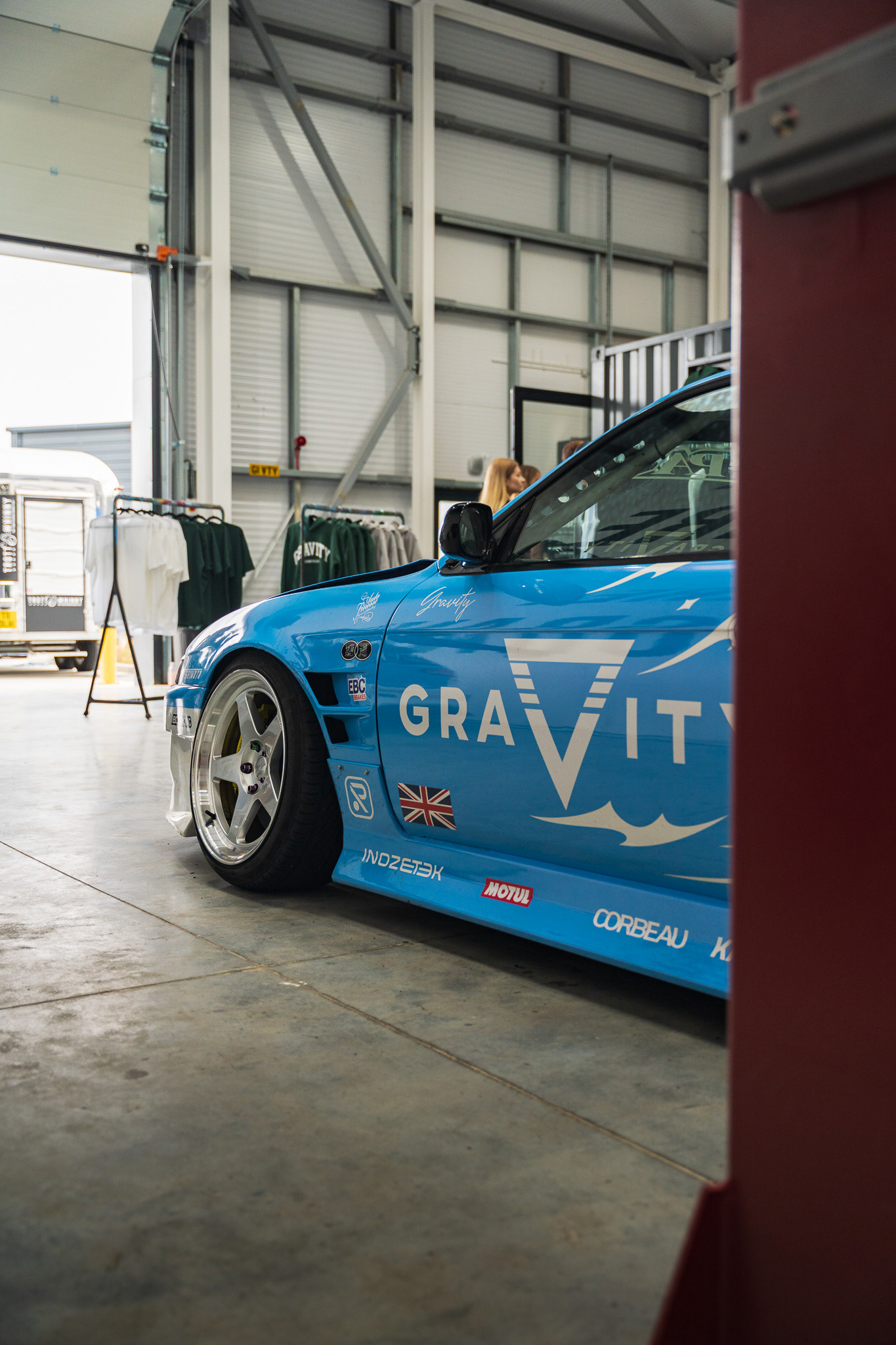 Wide body drift car Nissan Silvia S15  displayed indoors with dramatic showroom lighting Gravity HQ