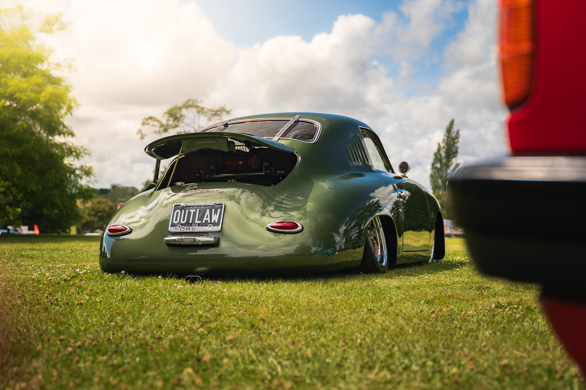 Rear view of lowered green car Porsche Outlaw 356 with wide stance in outdoor setting UK