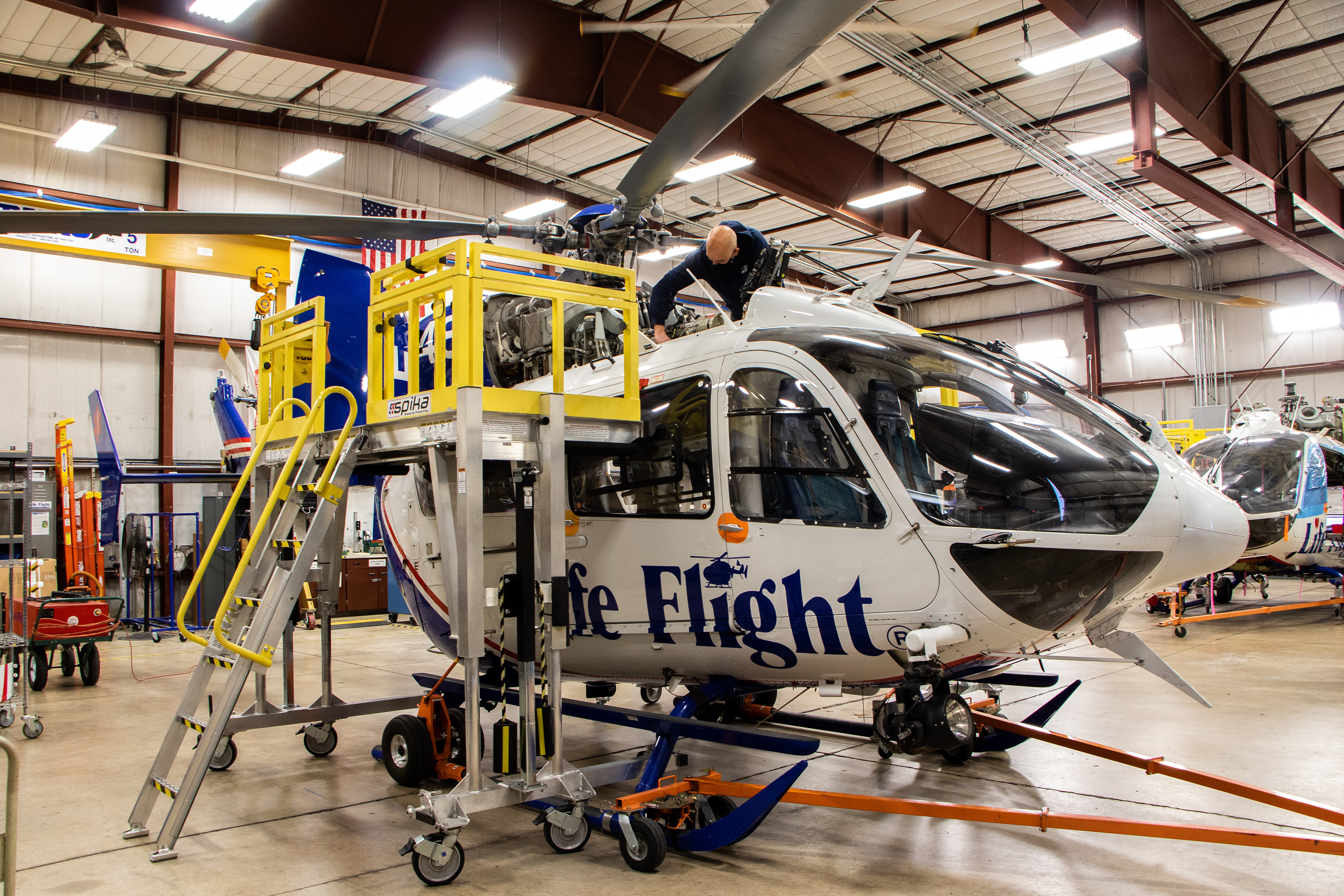 A Geisinger Life Flight mechanic works on one of their helicopters at their Danville, PA location.