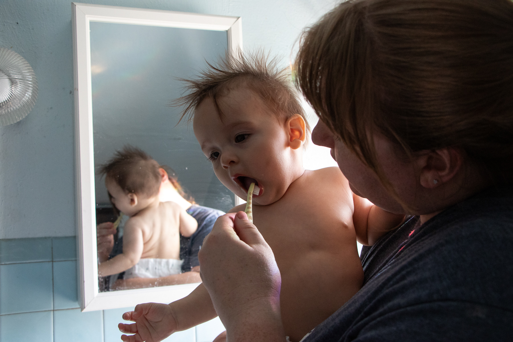 Isabelle brushes Hectors teeth before his evening bath.