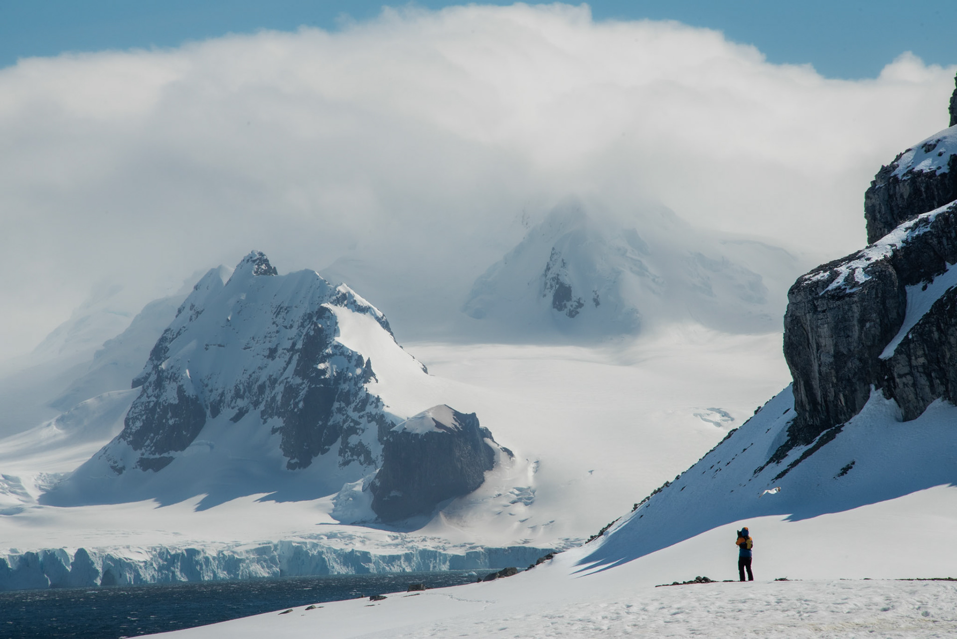 Antarctica. Taking in the view. Or possibly just keeping his fingers warm.