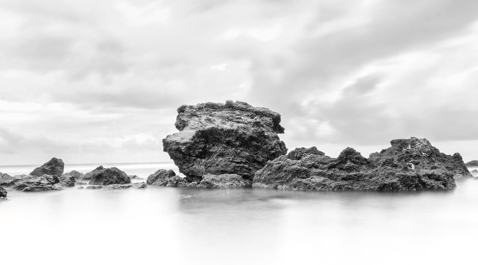 The square rock in this Black and white photo
