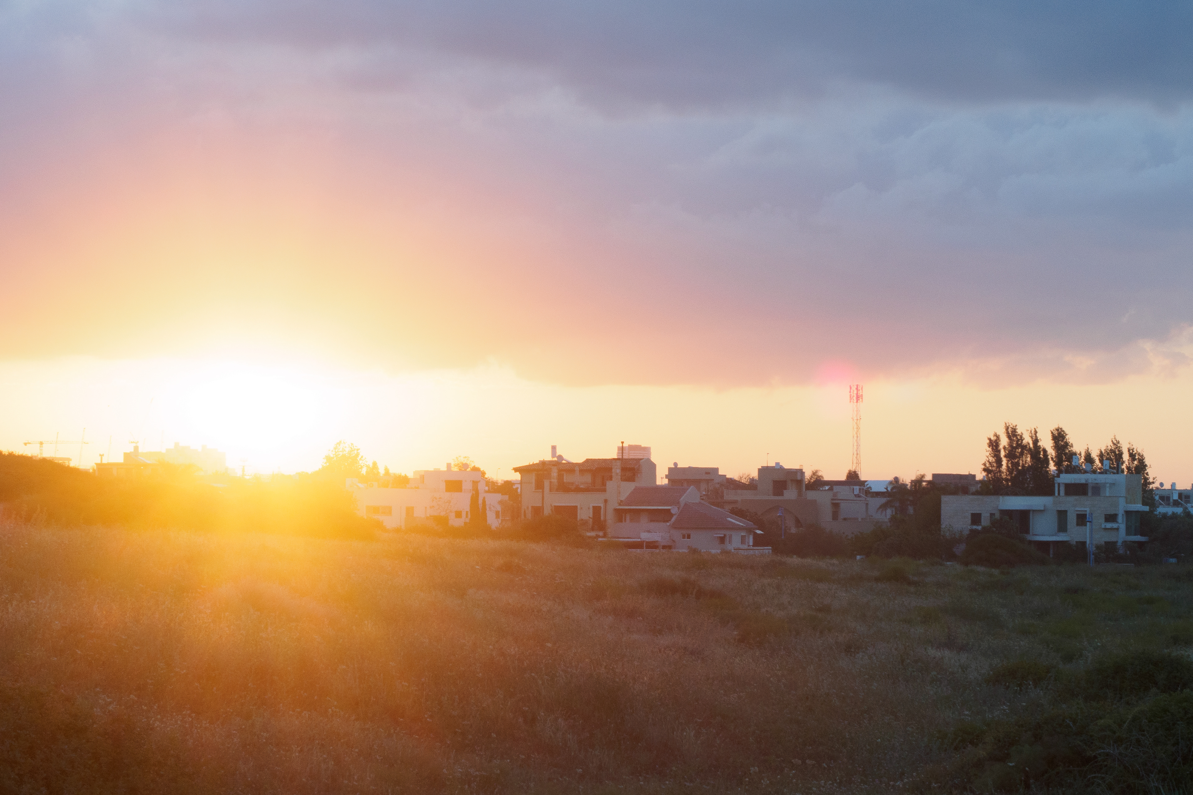 Sunrise over Givaat Olga with clouds and houses