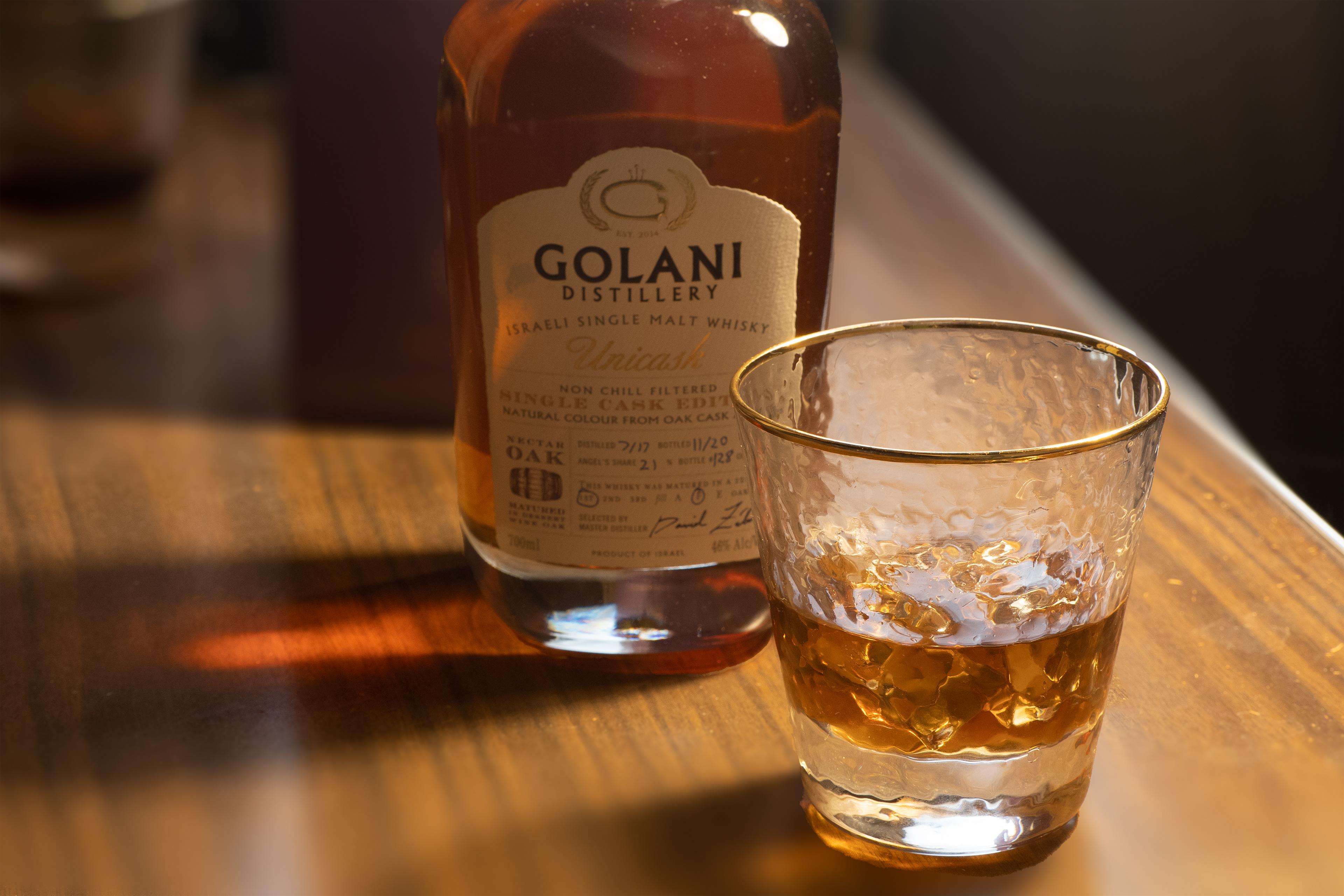 Golani whiskey bottle with a glass of whiskey