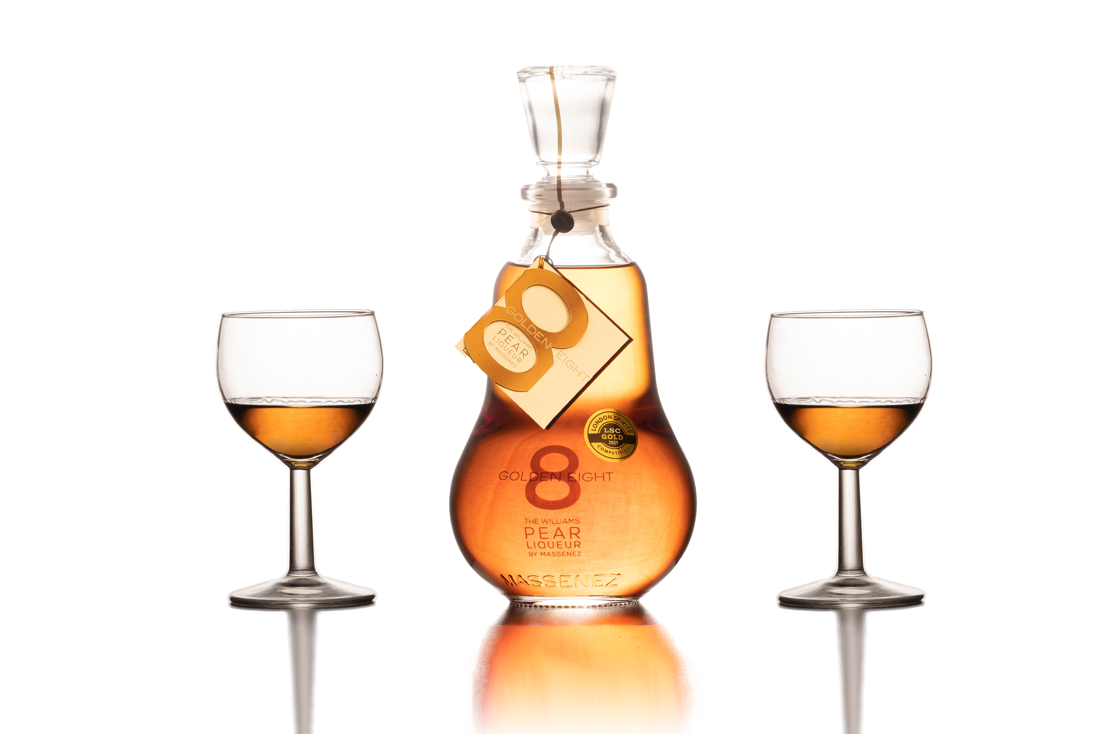 Pear liquor bottle with two glasses of the liquor