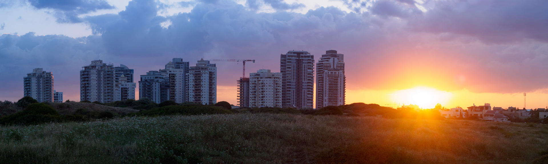 Sunrise over the hills and buildings of Givaat Olga area.