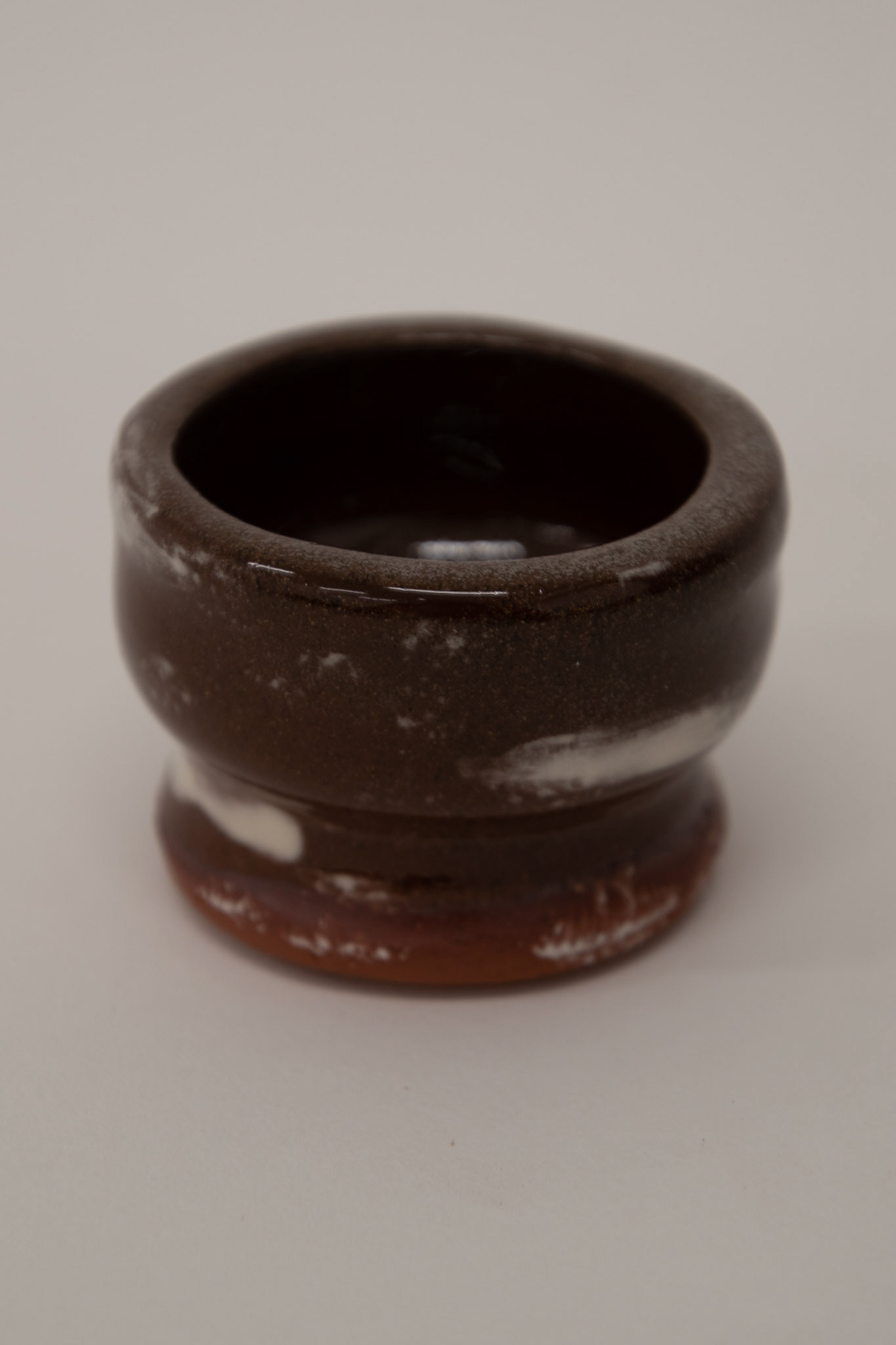 Clear shiny glaze on top of sponged on white slip from frottage
