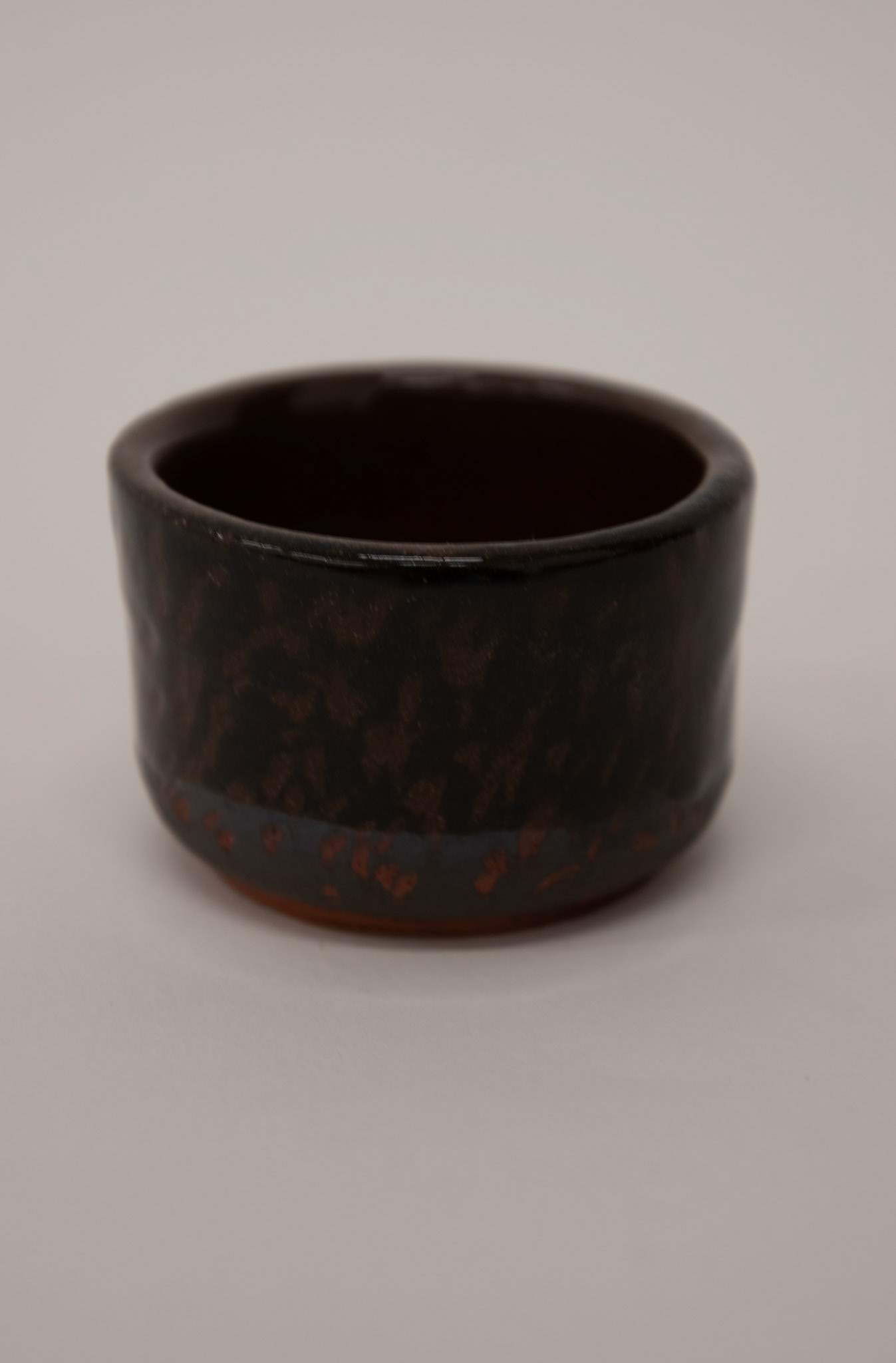 Clear shiny glaze on top of sgraffito black slip from frottage
