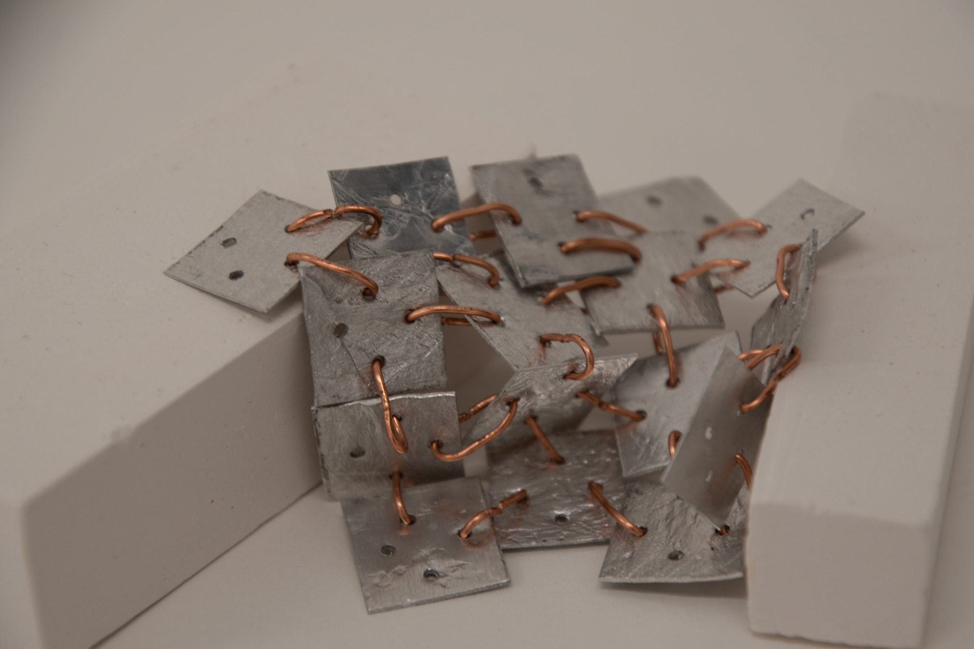 Rolled aluminium linked with copper jump rings exploring flexible movement in 3 planes