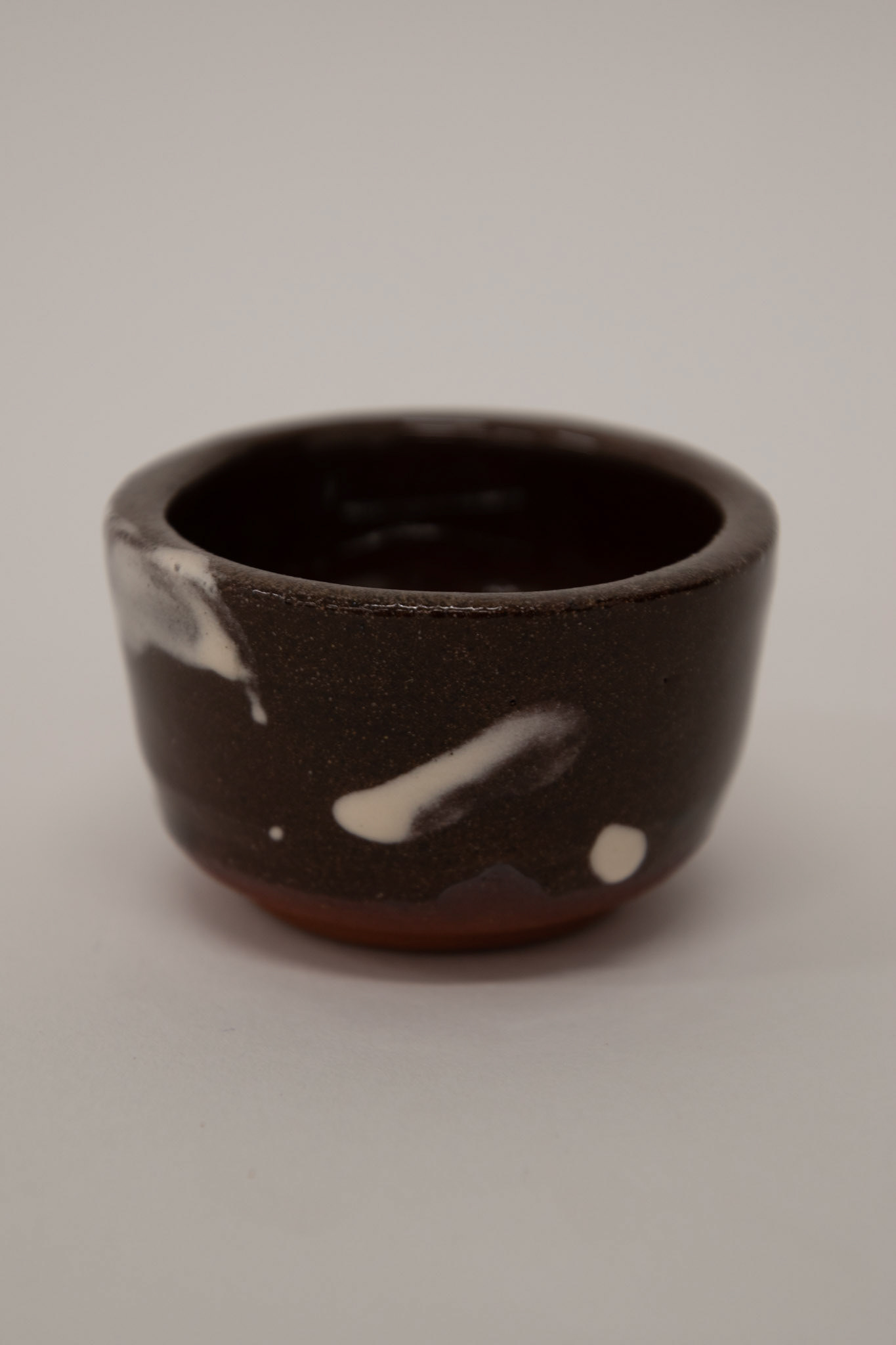 Clear shiny glaze on top of white and red slip