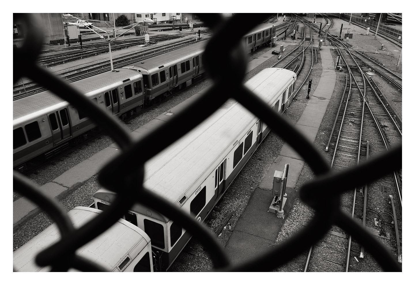 Red Line Cars Seen Through Overpass Fence