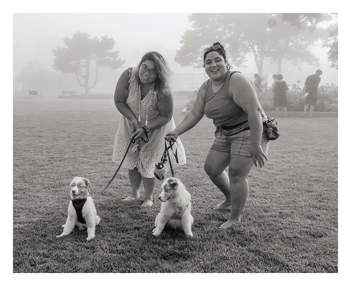 Two Young Women With Dogs in the Fog
