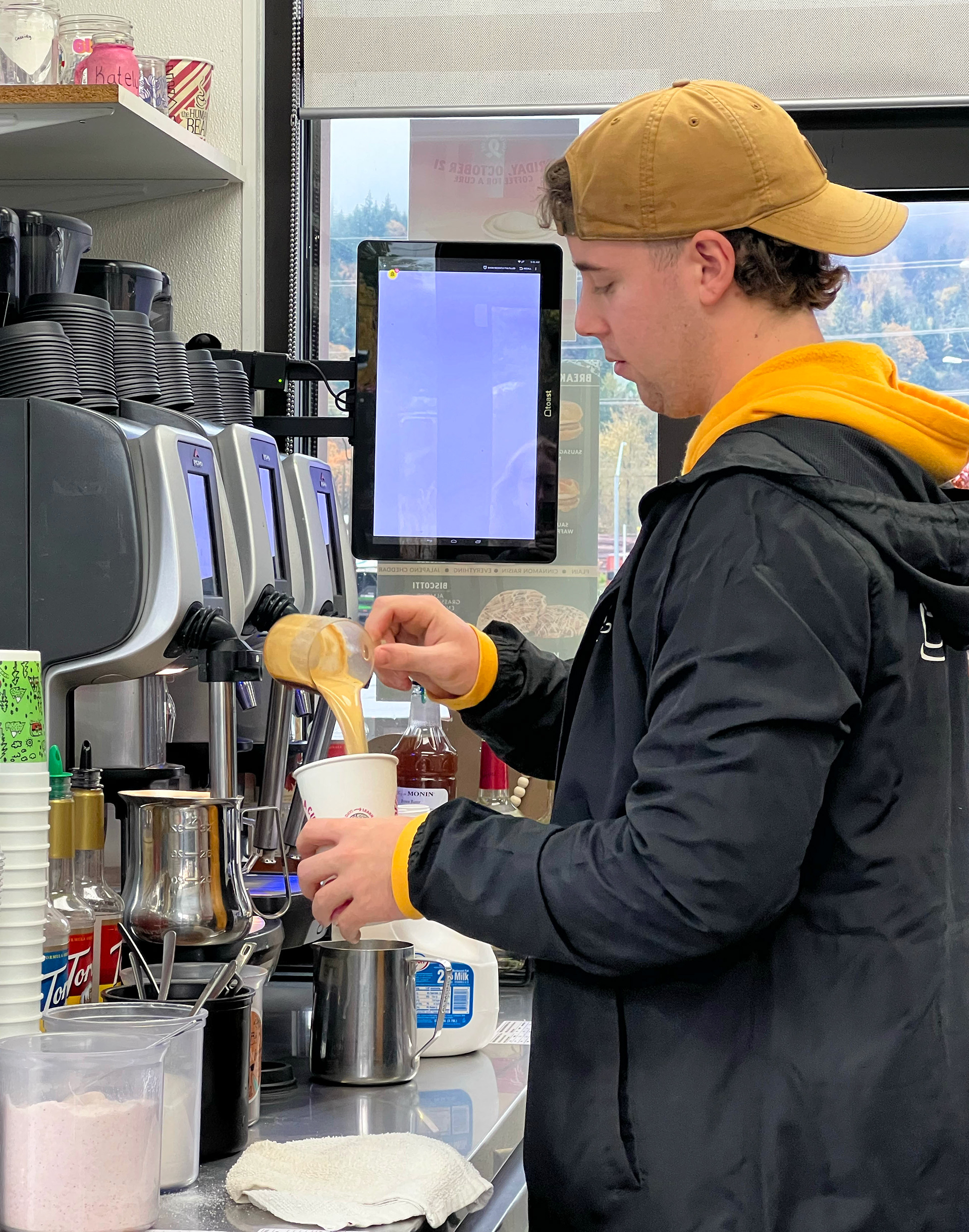 Fankhanell pours steaming hot espresso as he crafts a customer’s order, on a cold Eugene morning.