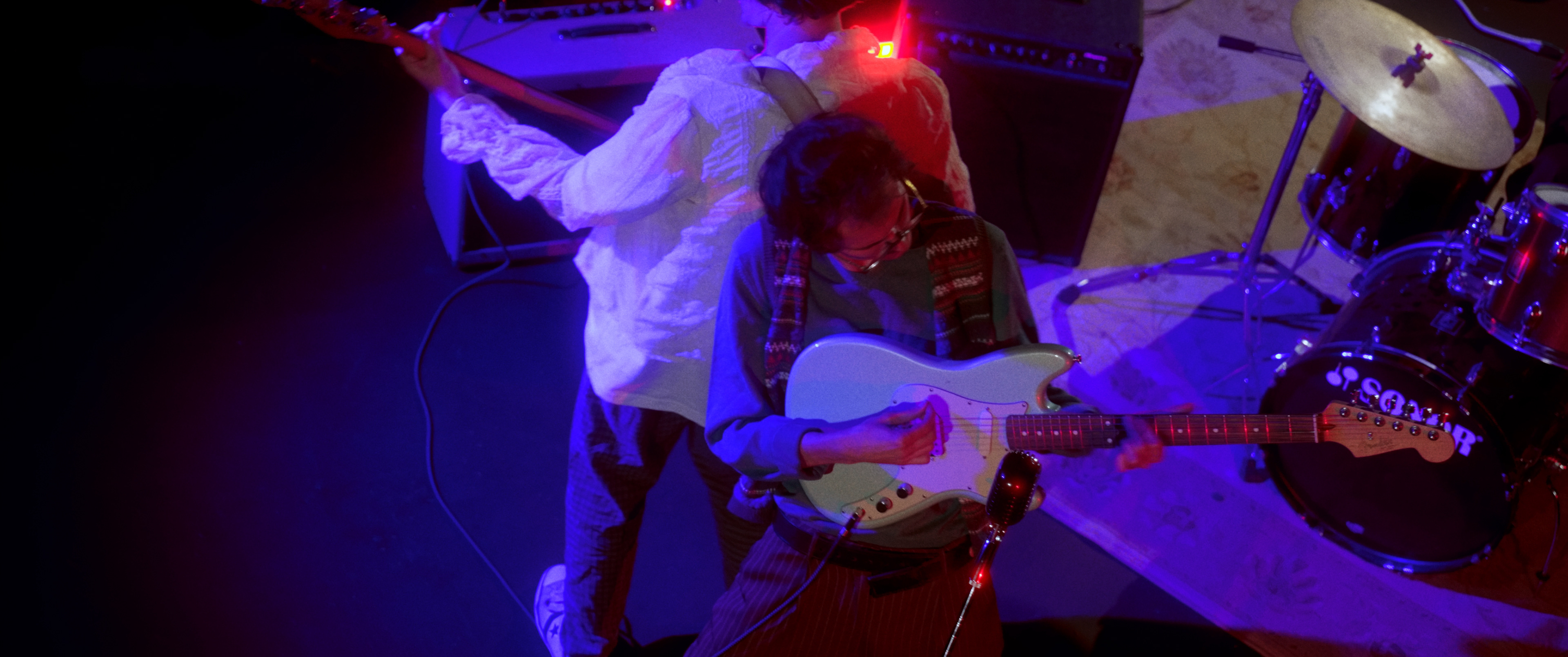The director makes an appearance as the bassist for the band scene.