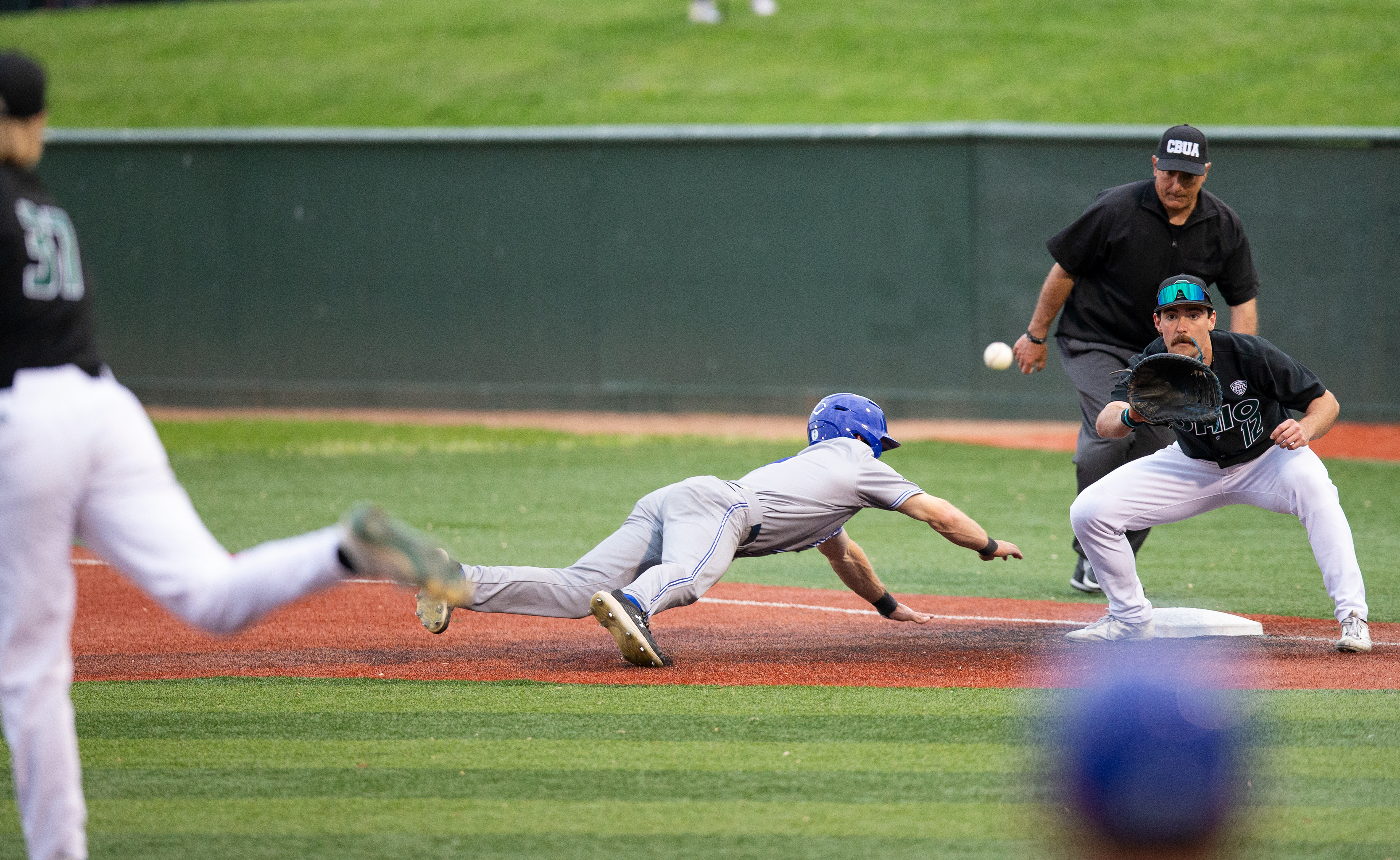 Ohio right hand pitcher, Patrick Straub (37), throws the ball to Ohio infielder, Bryce Smith (12), as Morehead State outfielder, Ryley Preece (9), slides back into first base during a game against Morehead State at Bob Wren Stadium, April 23, 2024, in Athens.