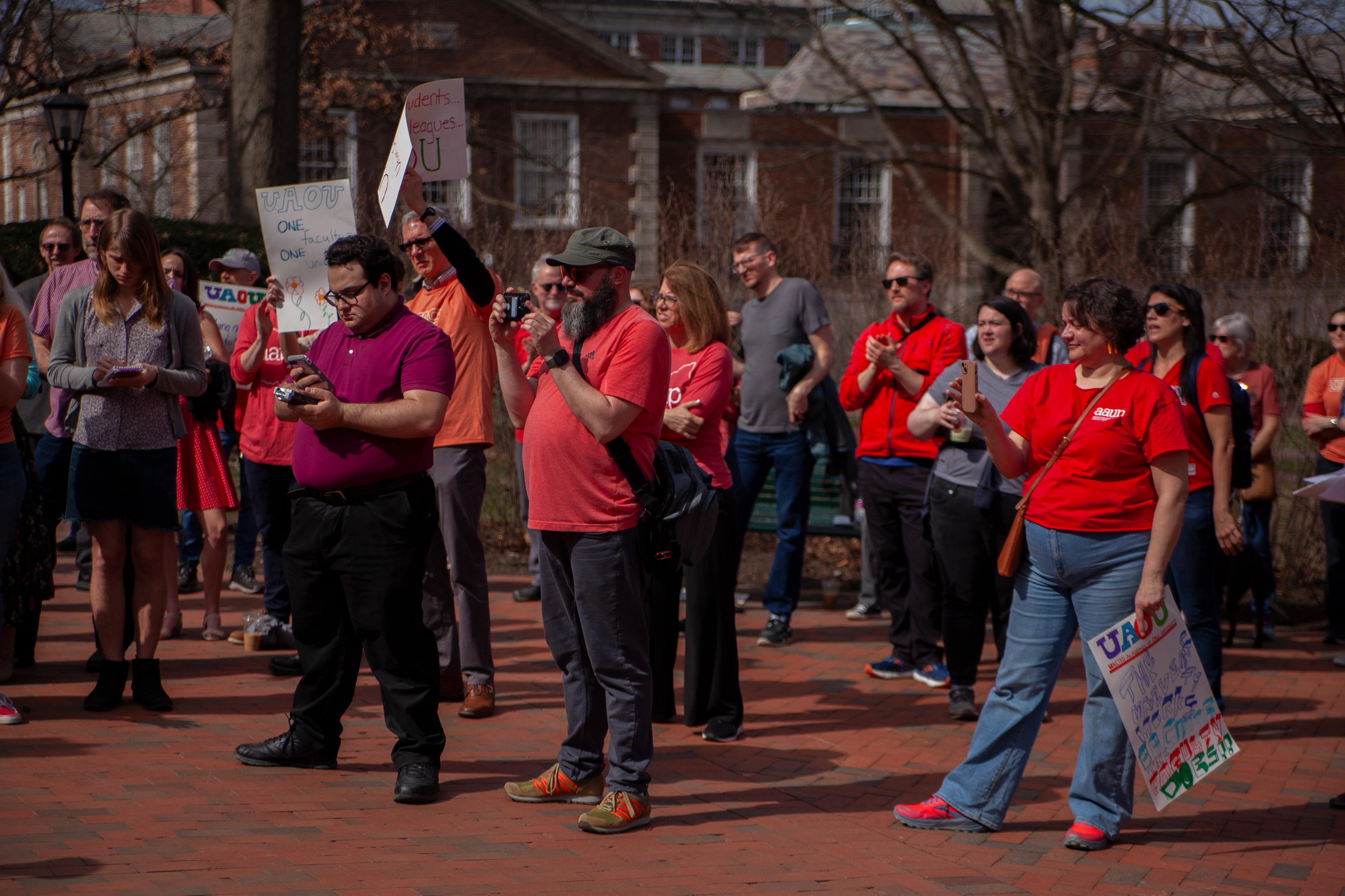 People gather and wear red in support of professors unionizing at Ohio University during the unionization protest on College Green, March 5, 2024, in Athens, Ohio.