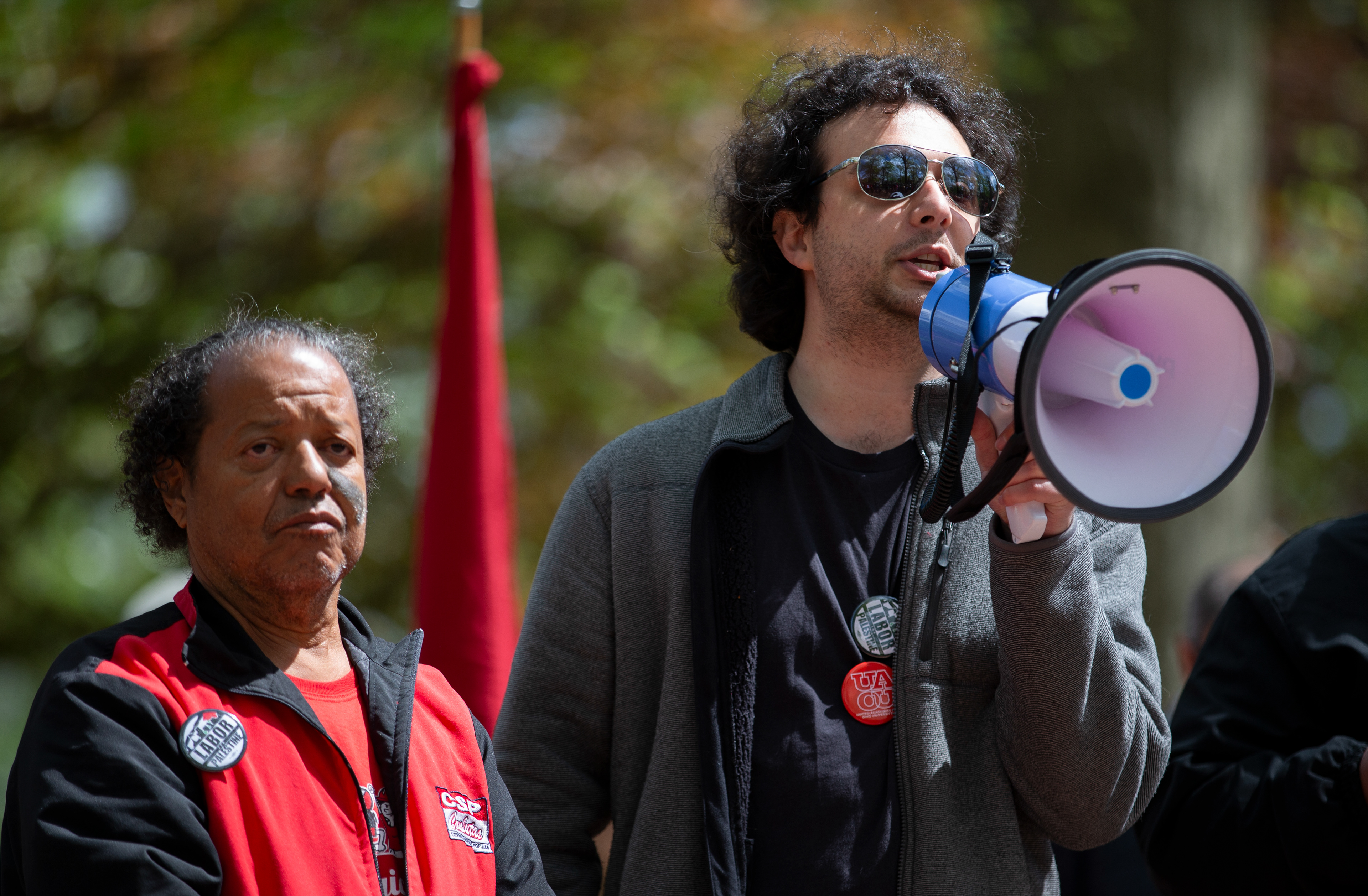 Luiz Carlos Prates (left) and Jonathan Angle (right) speak to the crowd at a rally hosted by United Academics of Ohio University on College Green, April 24, 2024, in Athens.