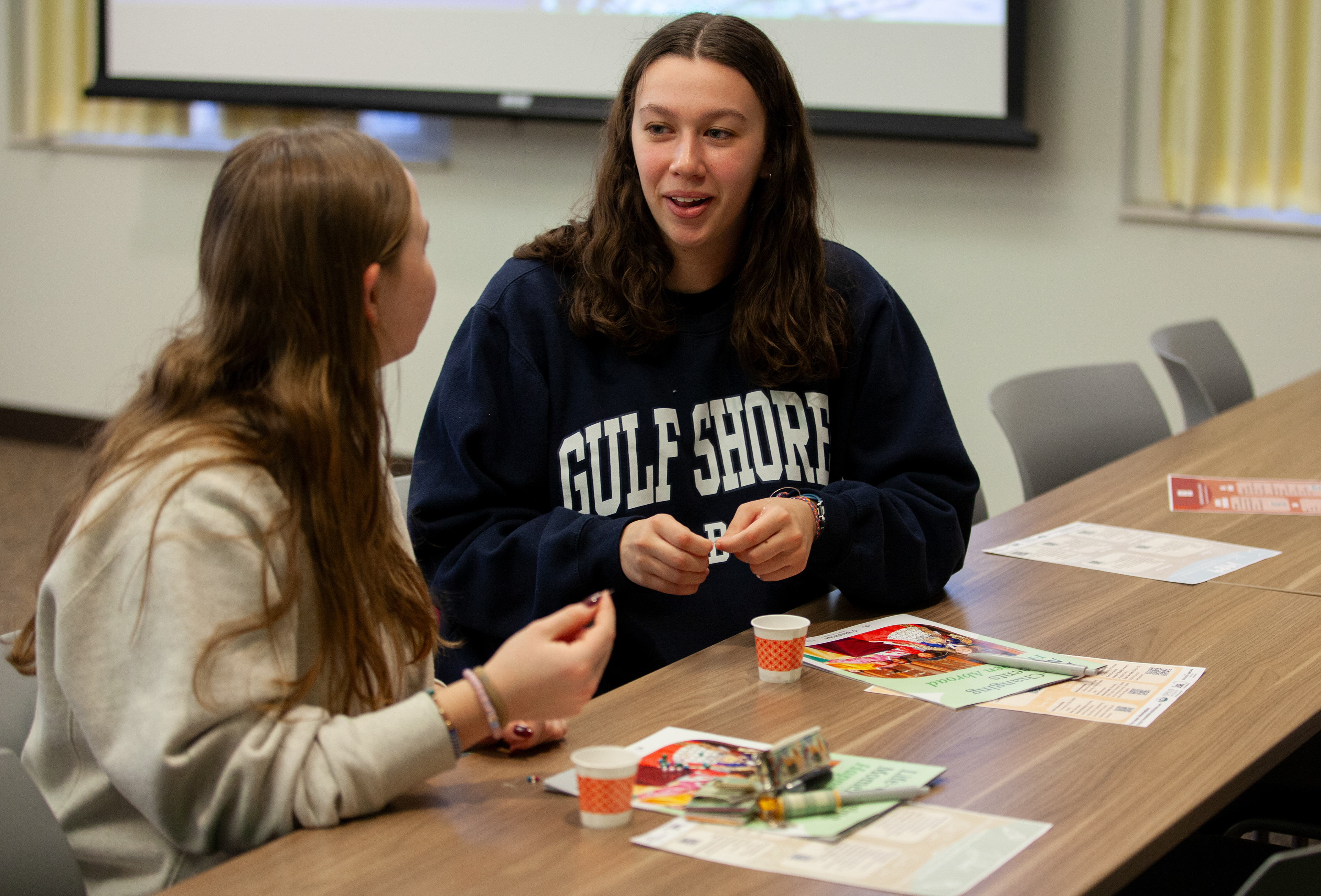 Allyson Webb (right) talks to Carly Traut (left) while making friendship bracelets at a study abroad information session hosted by Ohio University's Office of Global Opportunities with International Study Abroad by WorldStrides in John Calhoun Baker Center, Feb. 7, 2024 in Athens, Ohio. The event was put on as a Taylor Swift themed event for students to find the right fit study abroad program.