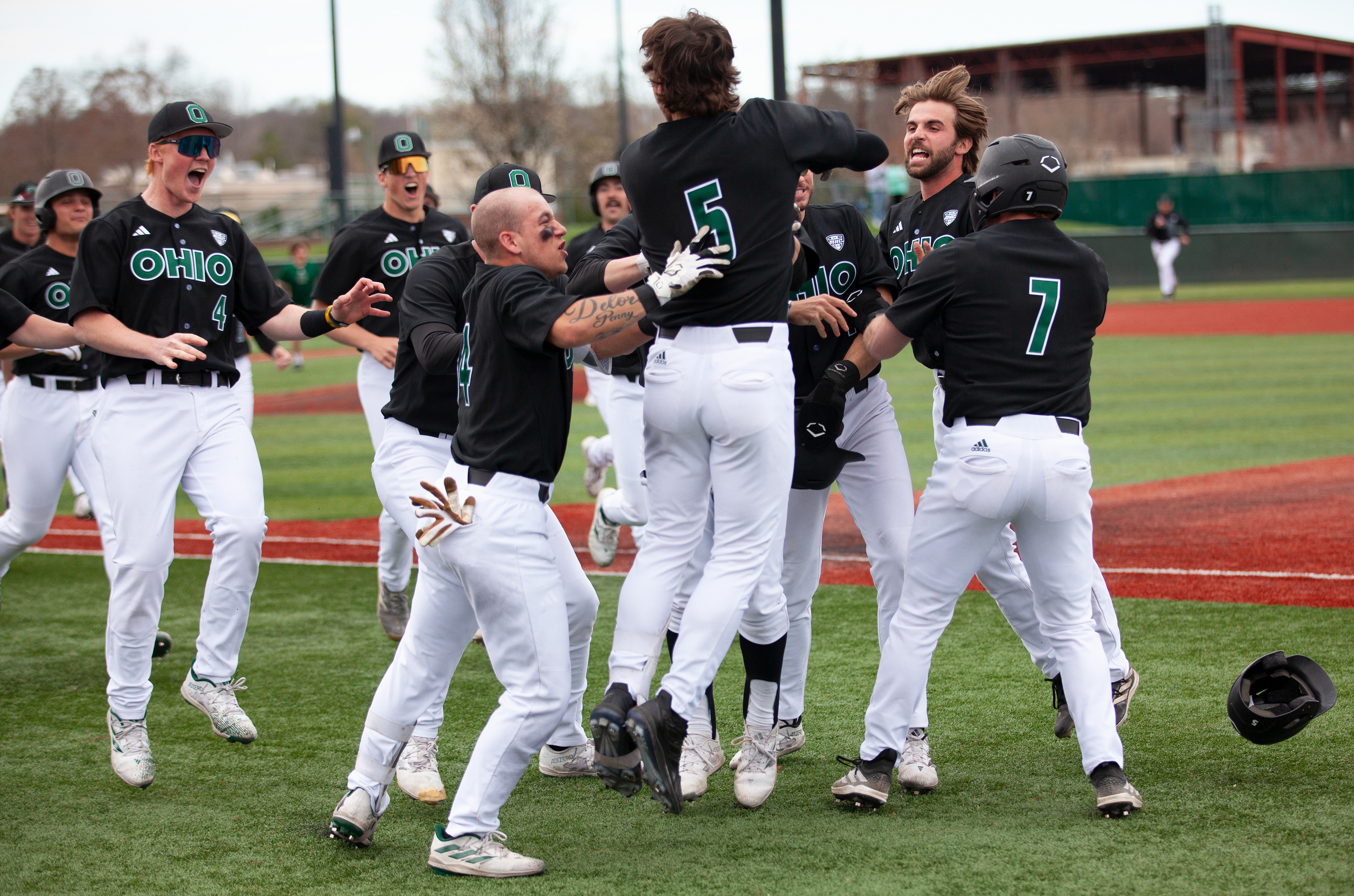 Ohio baseball players celebrate their win against Kent State at Bob Wren Stadium, March 16, 2024, in Athens.