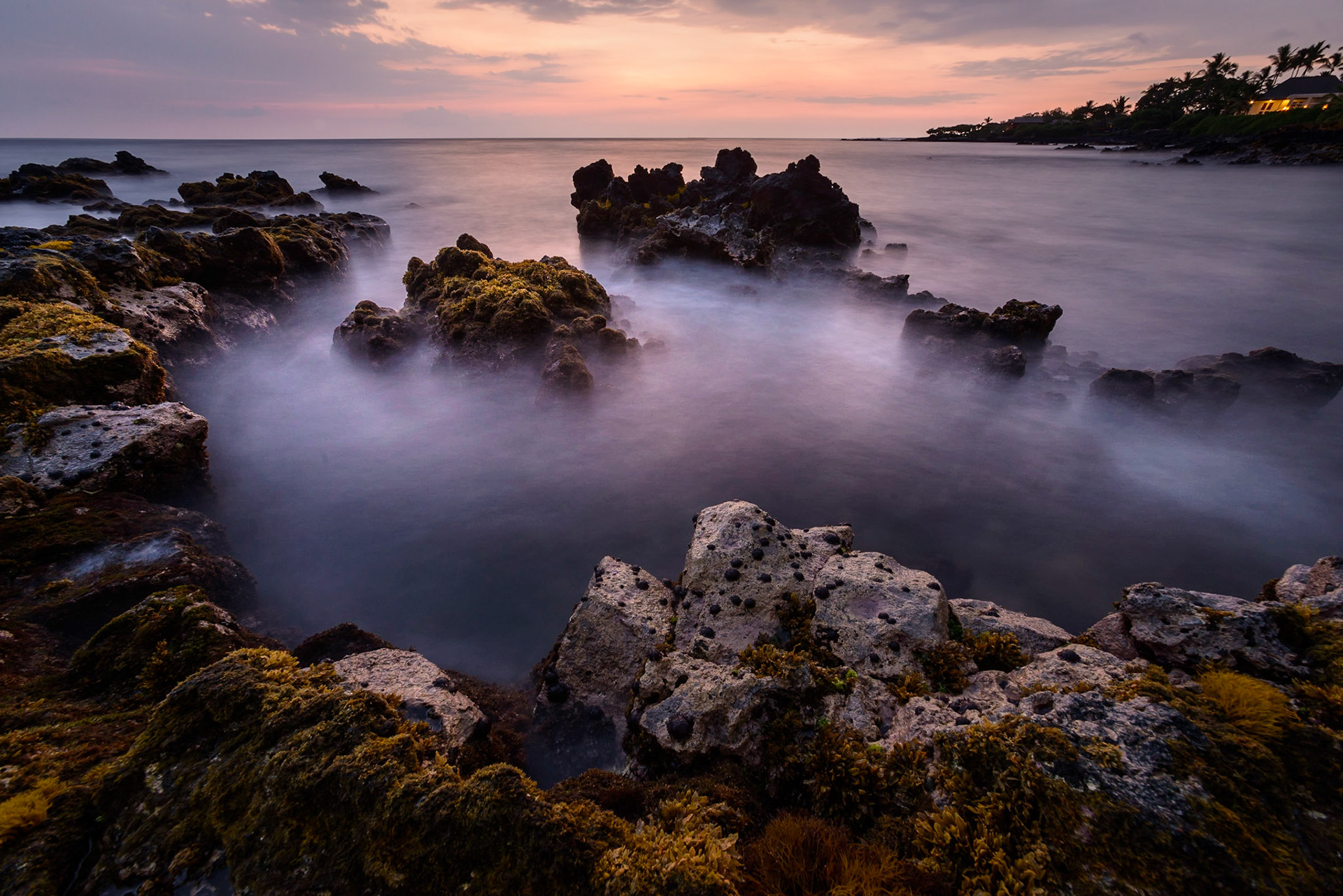 Waves of the Pacific Ocean crash against the Kona, Hawaii shoreline.