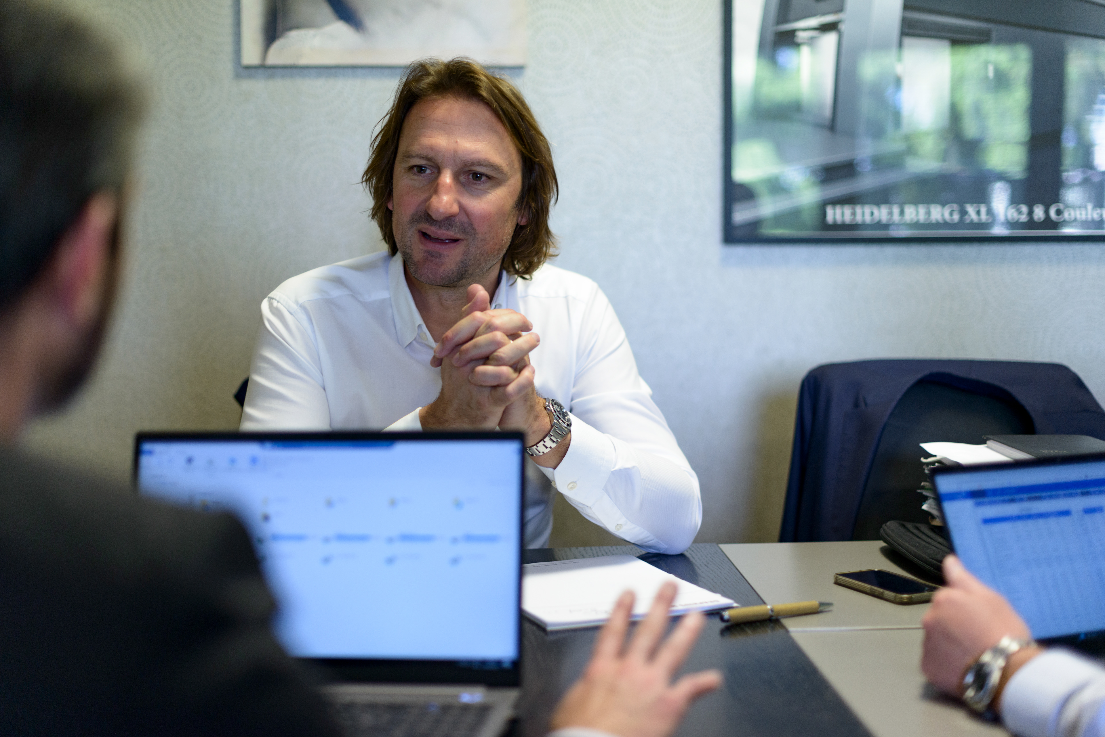 Denis Geers (right), CEO of the Graphius Group, a leading printing group founded in Ghent, Belgium in 1928, discusses operations in a meeting with his brother Philippe Geers (right), CFO of the Graphius Group, and Stéphane Robert (left), General director of PPO Graphic at the PPO Graphic site outside of Paris. Part of the Graphius Group, PPO Graphic specializes in the printing of comics and illstrated books. Palaiseau, France.