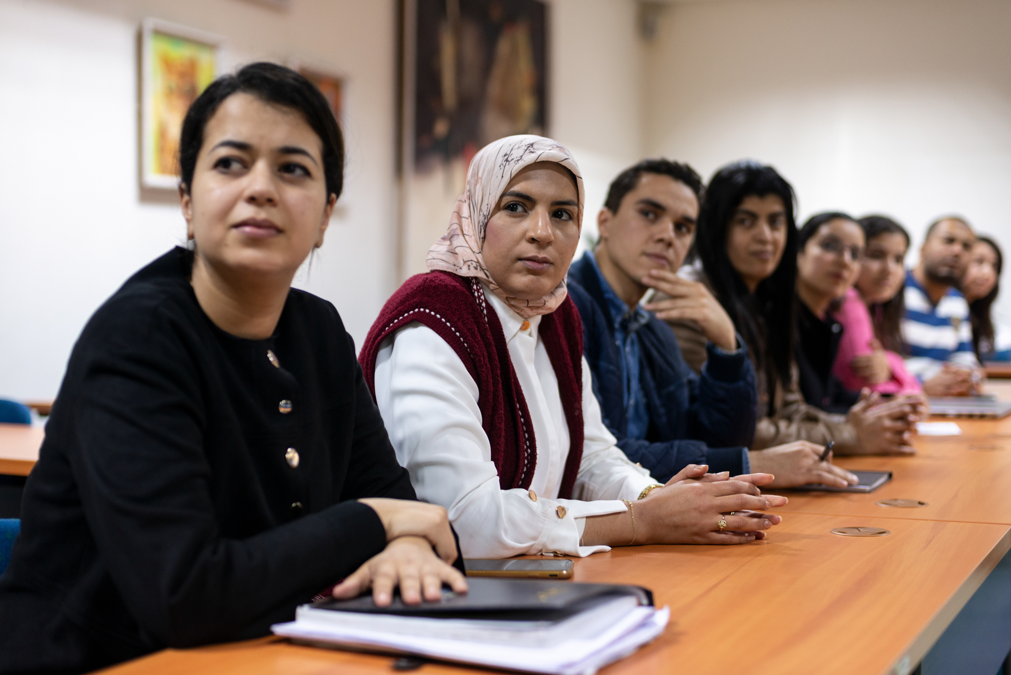 Researchers and staff meet with the director of Research and development, Dr. Mehdi El Harrak, in a conference room at the MCI Santé Animale laboratory.