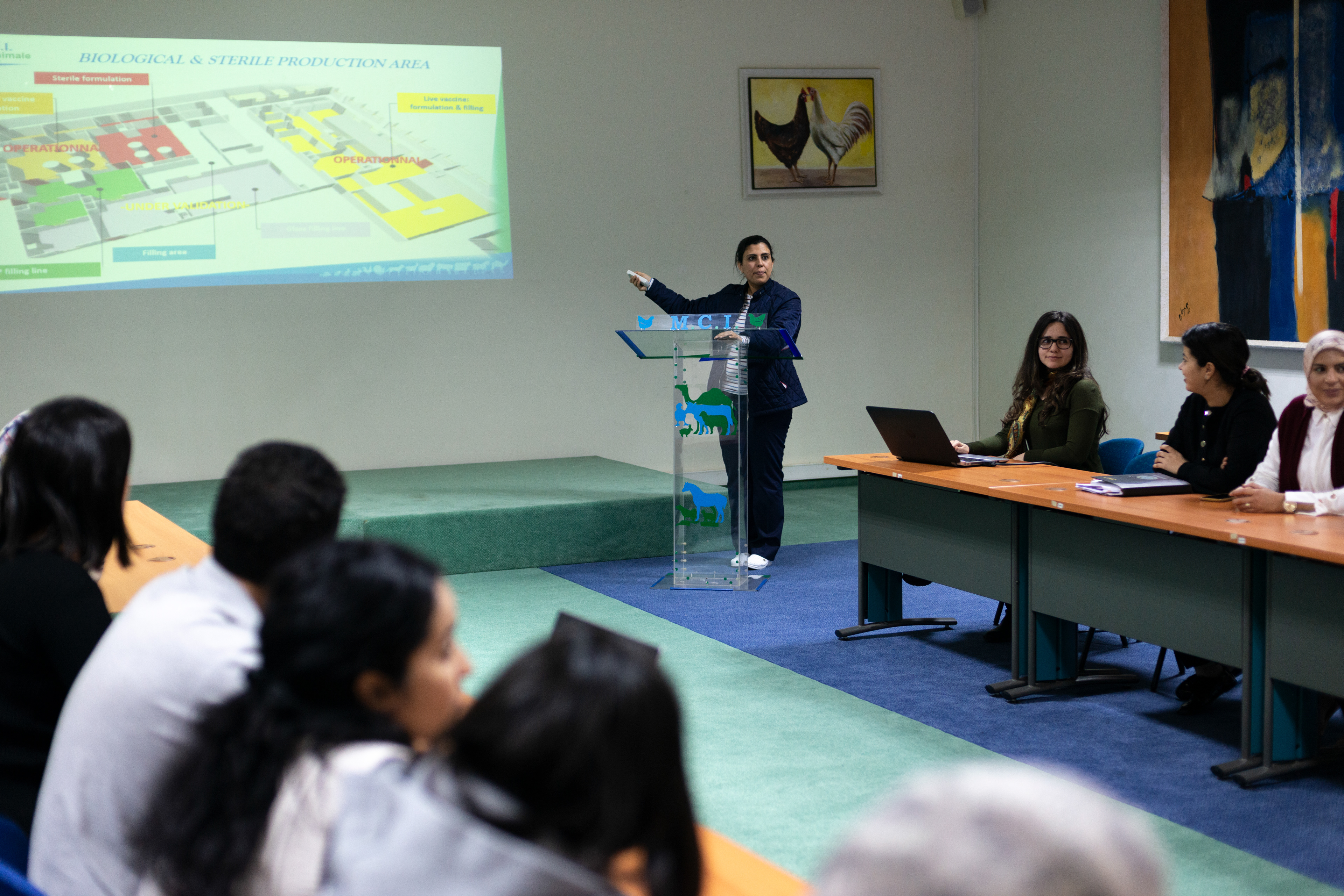 Researchers and staff meet with the director of Research and development, Dr. Mehdi El Harrak, in a conference room at the MCI Santé Animale laboratory.