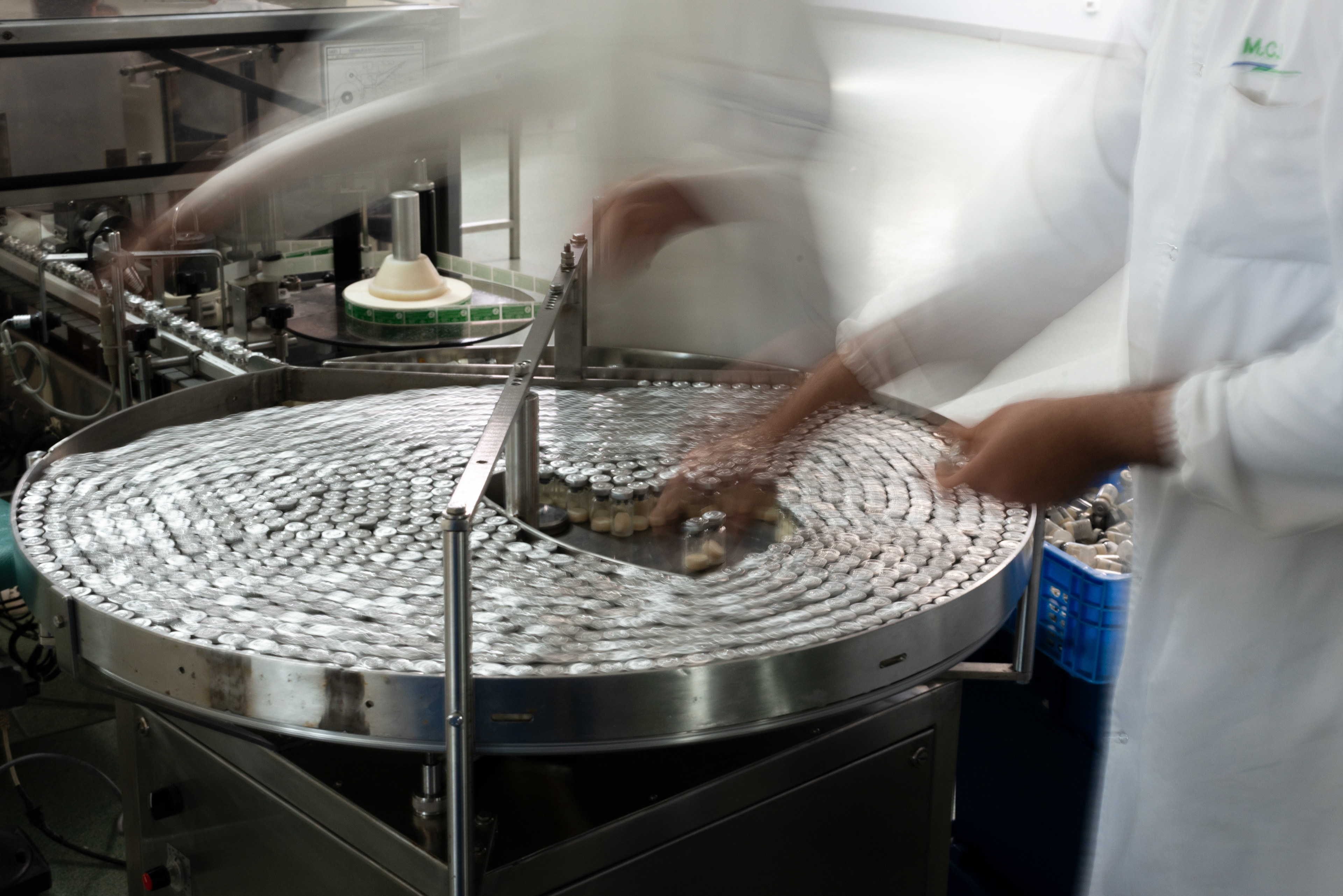Technicians preparing final products in the in the conditioning and packaging unit of the MCI Santé Animale laboratory.