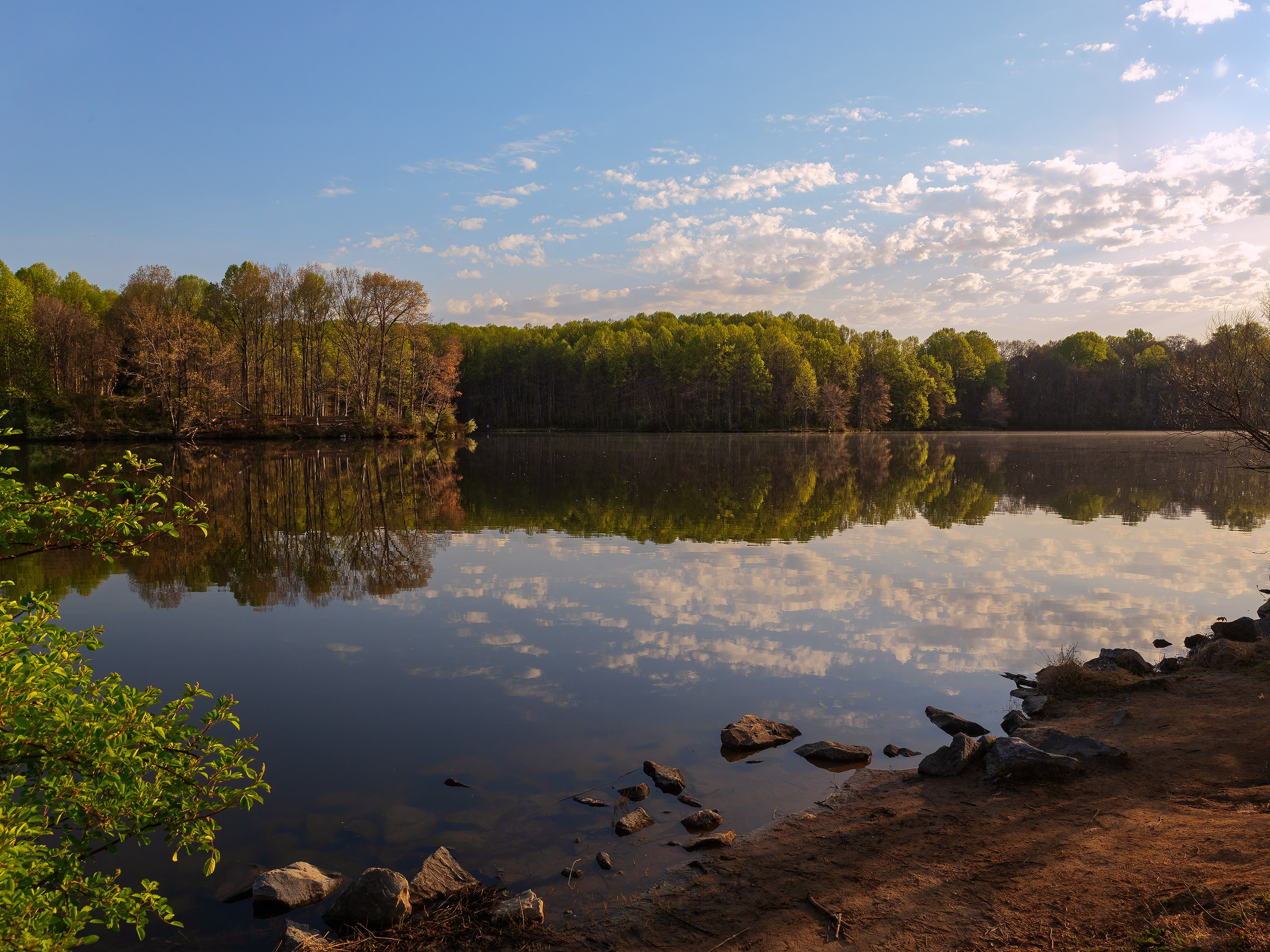 A beautiful Fall day at Centennial Lake in Columbia, Maryland, showcasing a colorful palette of autumn leaves.