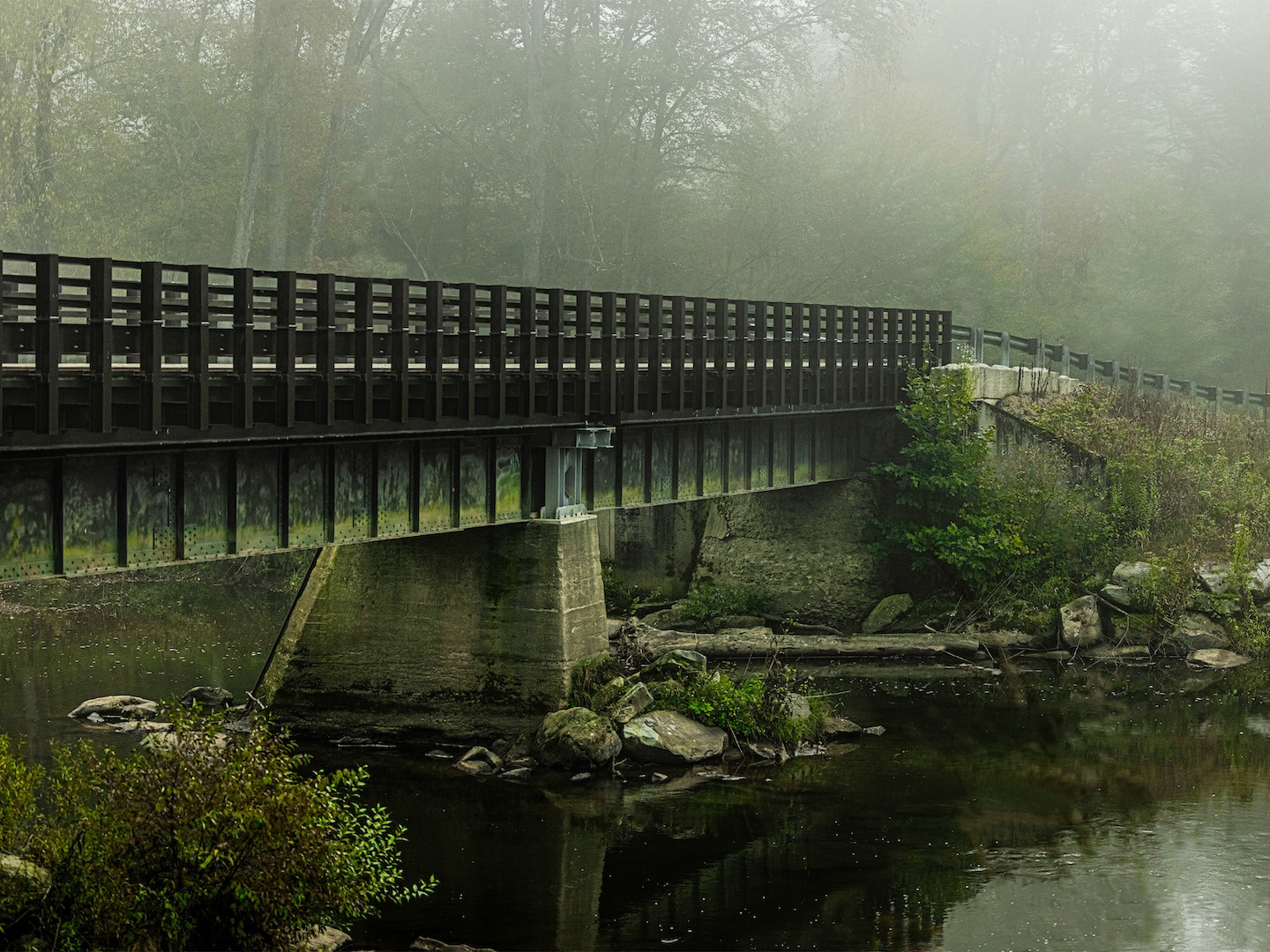 Misty steel bridge over a stream in PA.