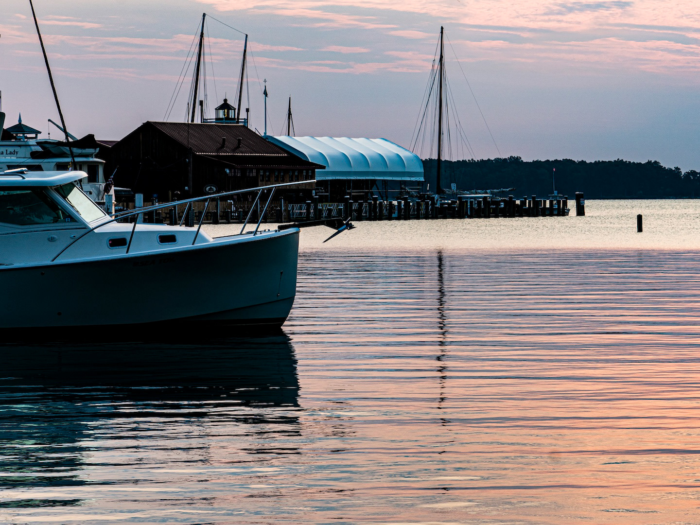 A beautiful sunrise at St. Michaels, Maryland, displays a colorful palette extending from the sky to the water, where boats await the new day.