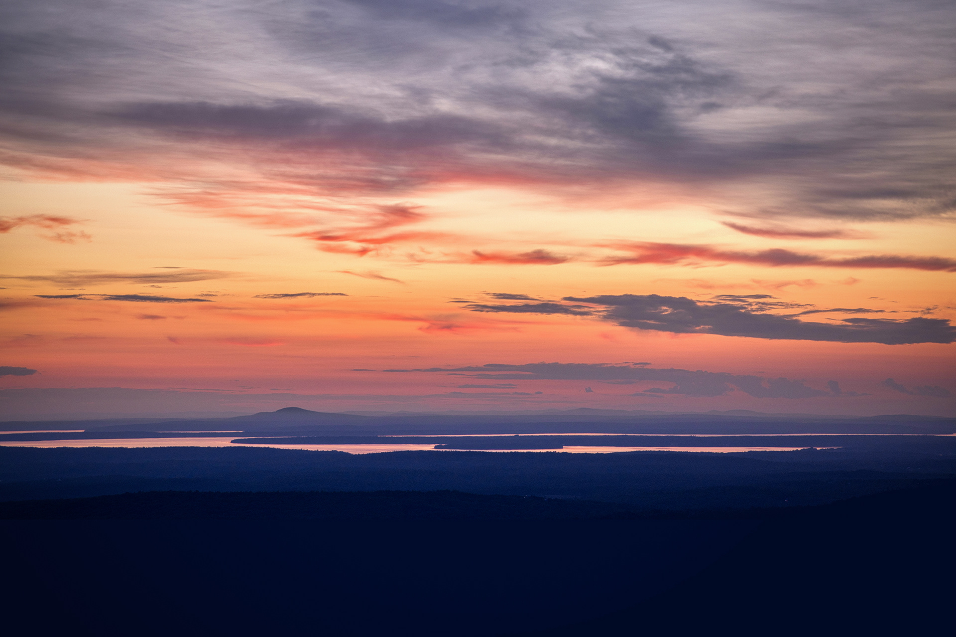 A bouquet of sunset-laced colors fills the sky in a beautifully layered conclusion to the day, viewed from Cadillac Mountain in Acadia National Park.