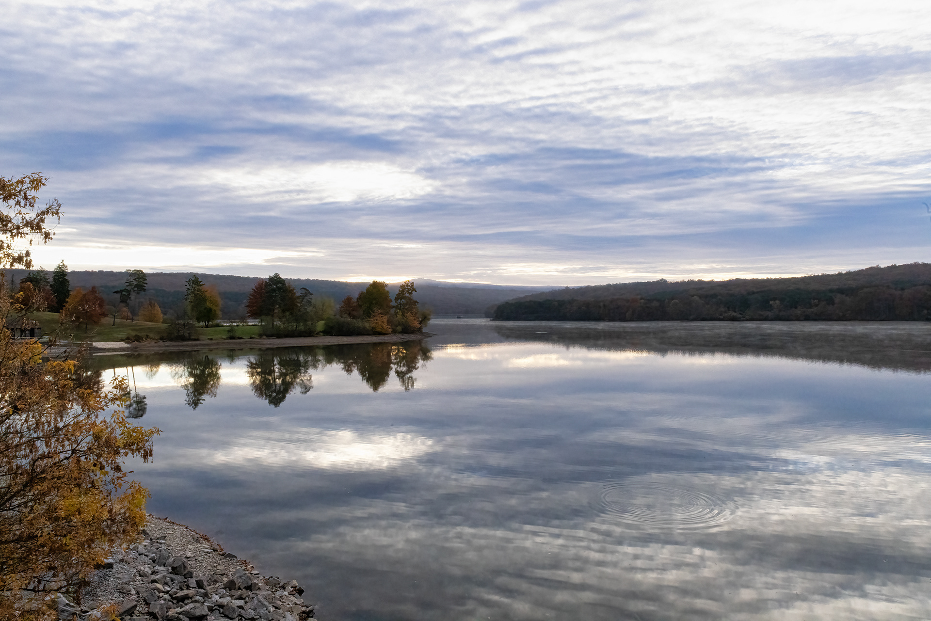 Calm waters reflect an overcast Fall day at Shawnee Lake in Shawnee State Park, Pennsylvania.