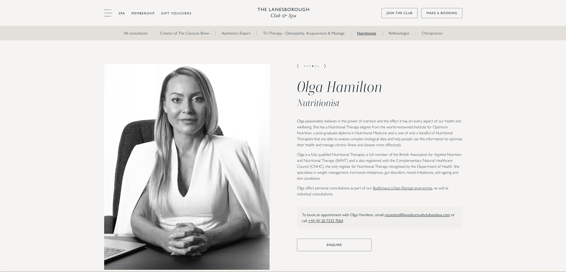 Black and white portrait of a Nutritionional Therapist, Olga Hamilton, seated at a desk in an office. Branding photograph by Cj Swaby Photography