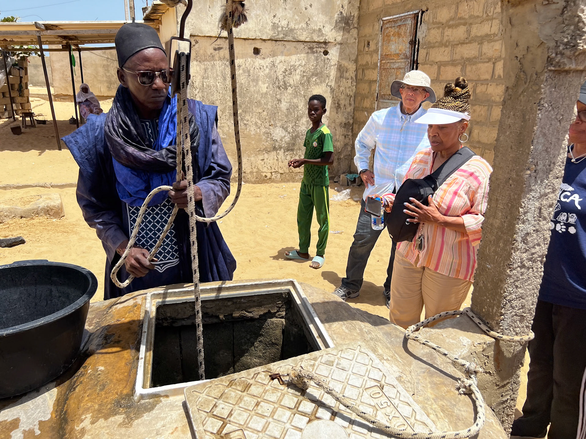 Water drawing demonstration performed by village leader, The Gambia, West Africa
